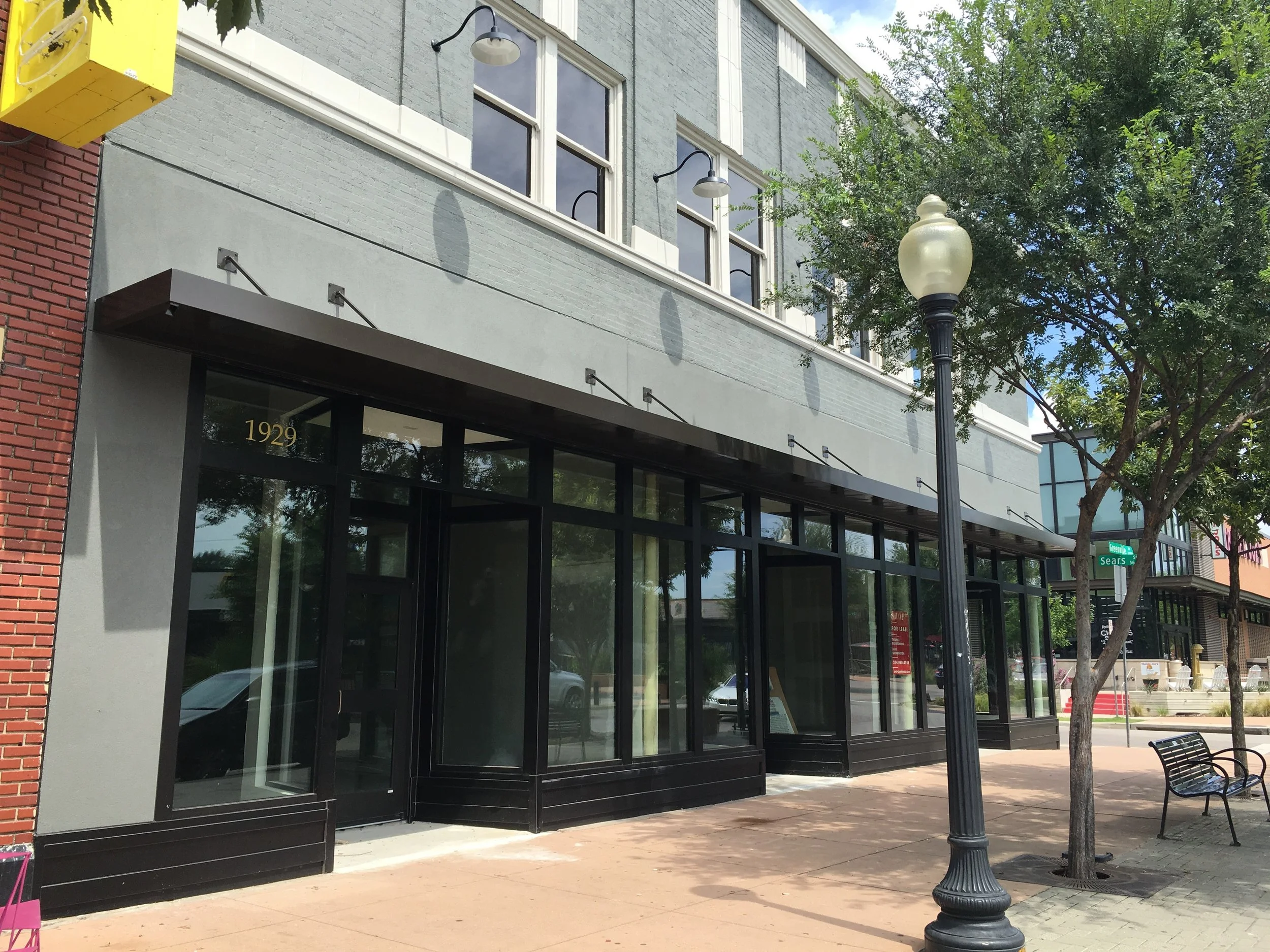 Replacement storefront in Lower Greenville district of Dallas, Tx. The new storefront mimics historic proportions, but is constructed out of metal parts. The original storefront had been removed years before.