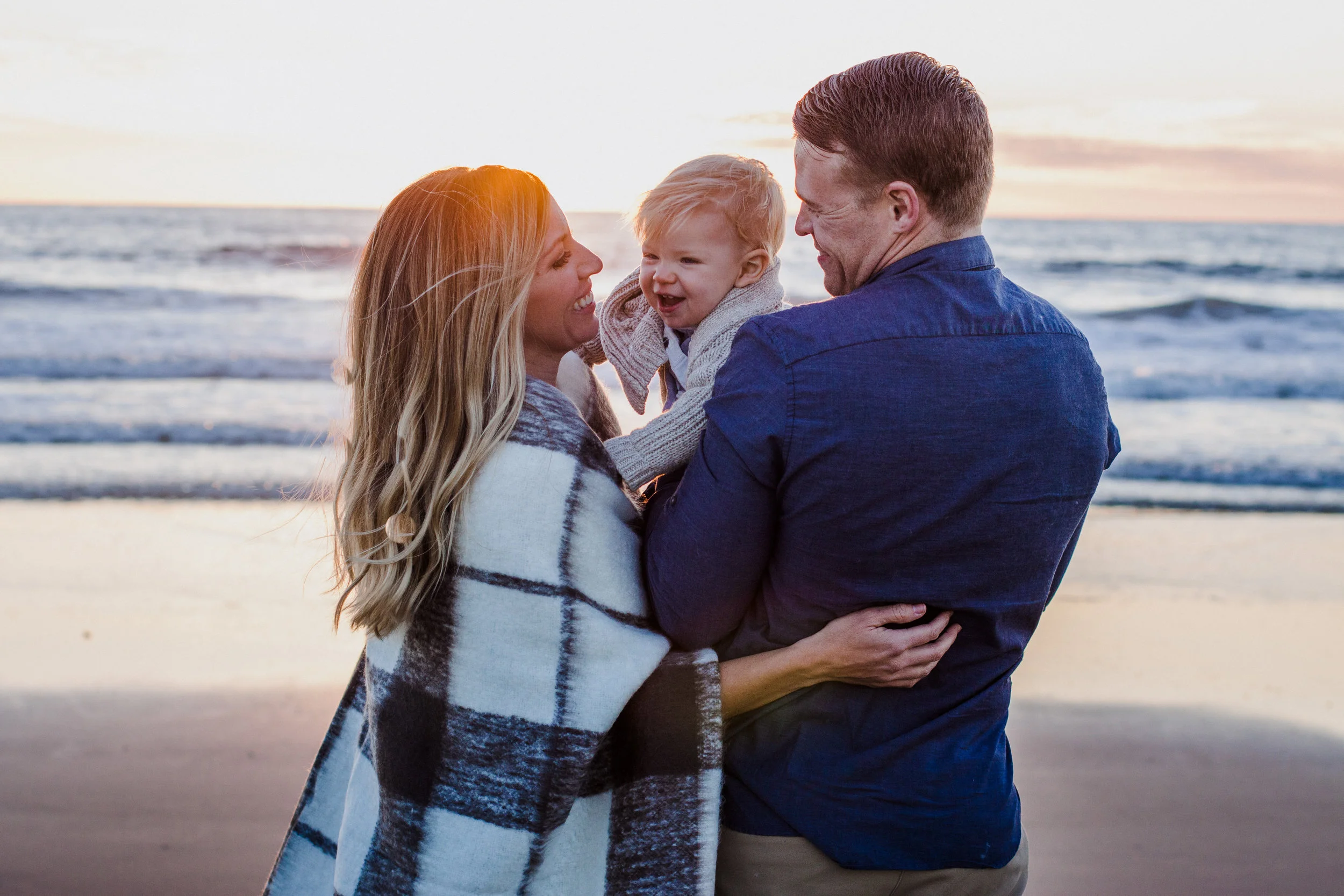 This gorgeous family likes to spend sunsets with their son on the beach. It's a favorite pass-time for them.