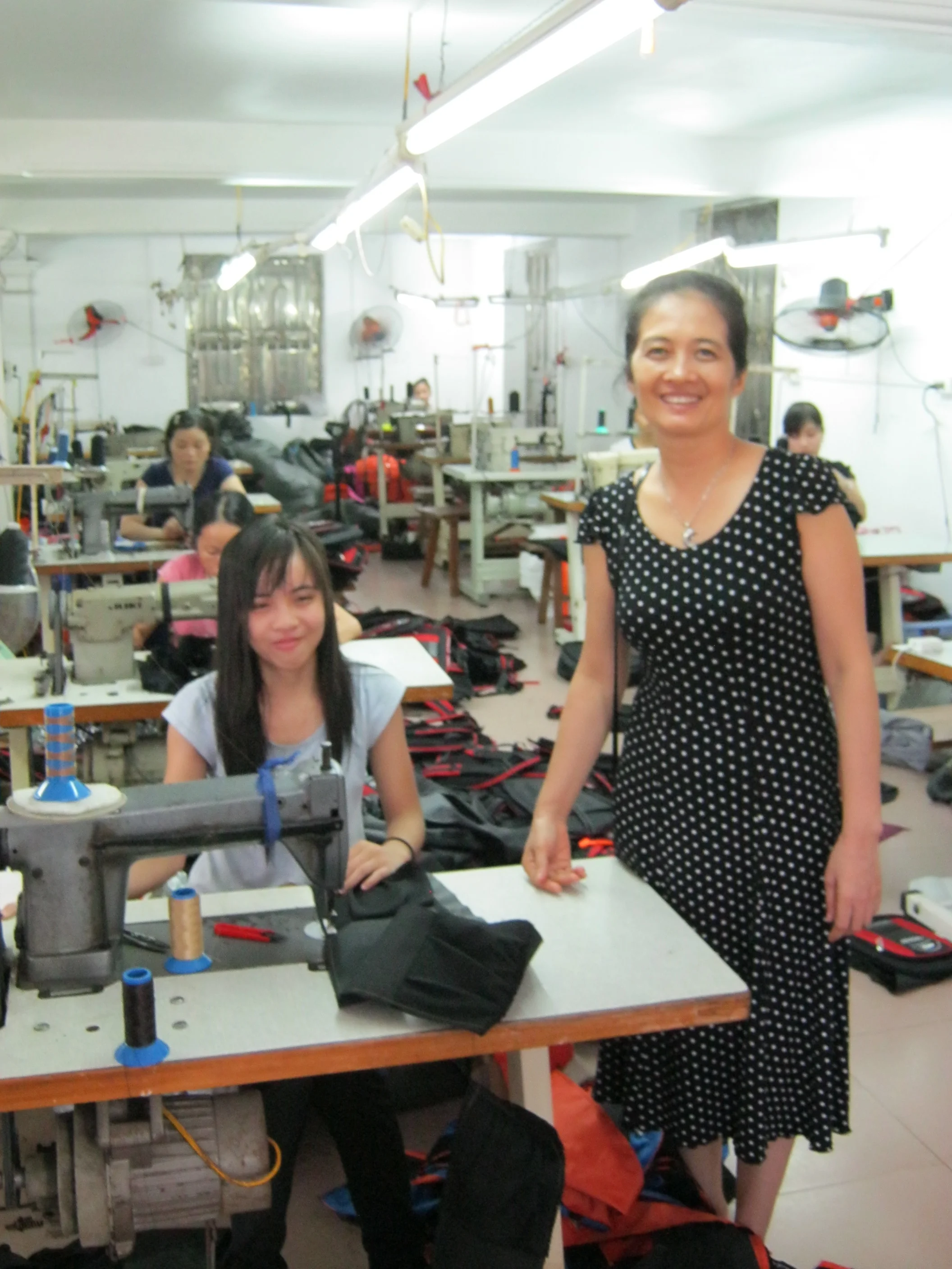 Mrs. Nga stands with employees in her factory.