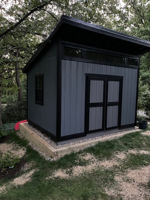 Shed on sloped site with timber surround