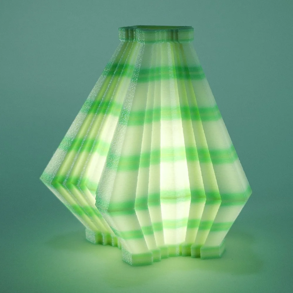 Single Facets night light in mint and lemon, glowing