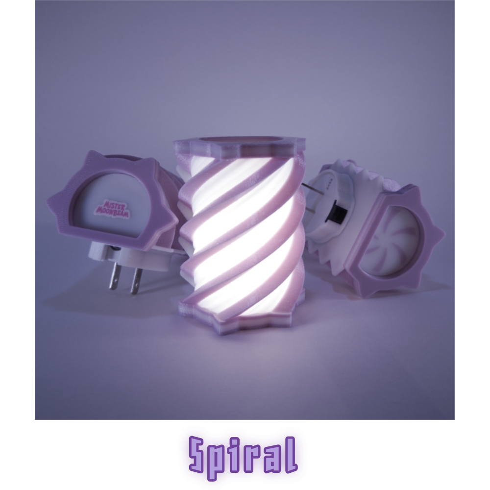 Three Spiral night lights in lavender and white, one glowing, with plug prongs visible