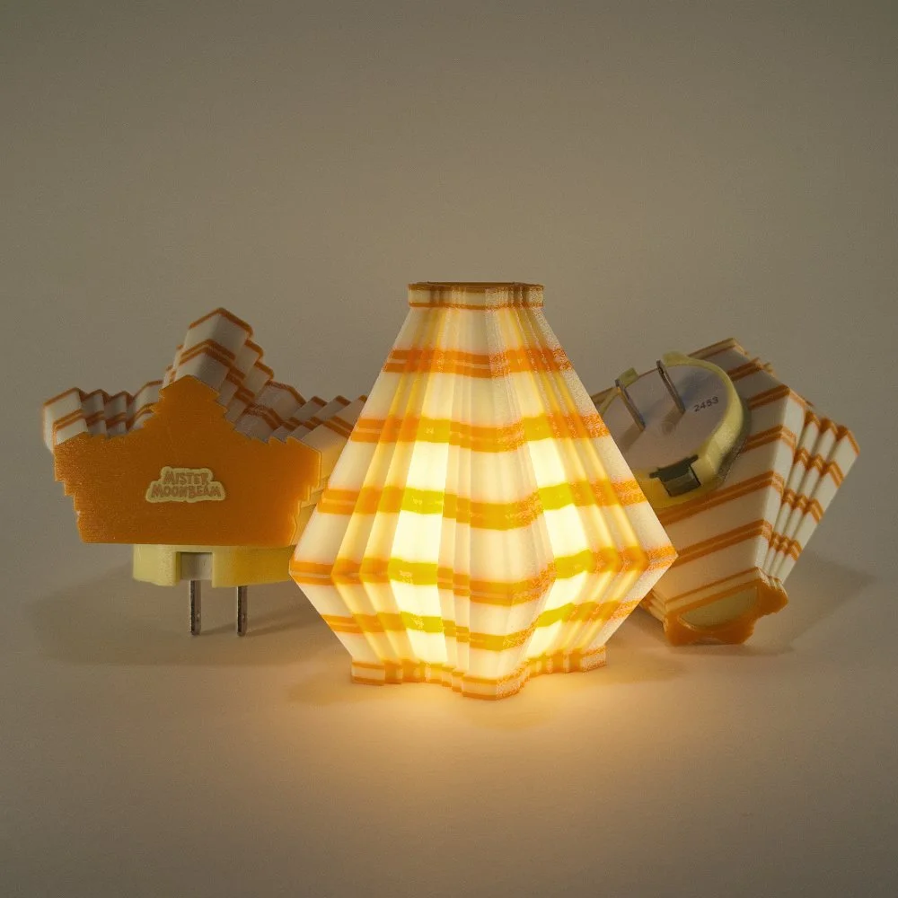 Three Facets night lights in orange and lemon, glowing