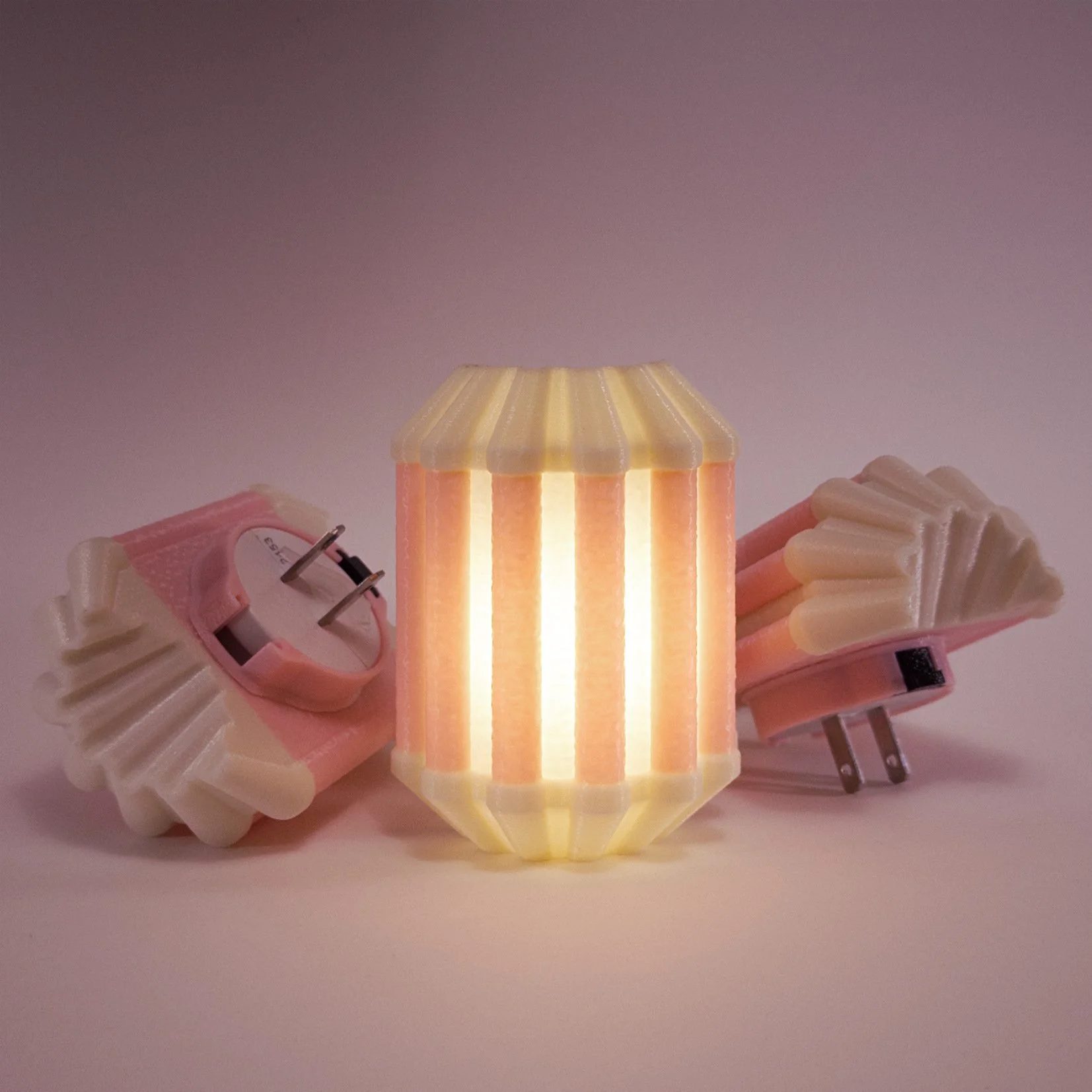 Three Drapes night lights in pink, glowing