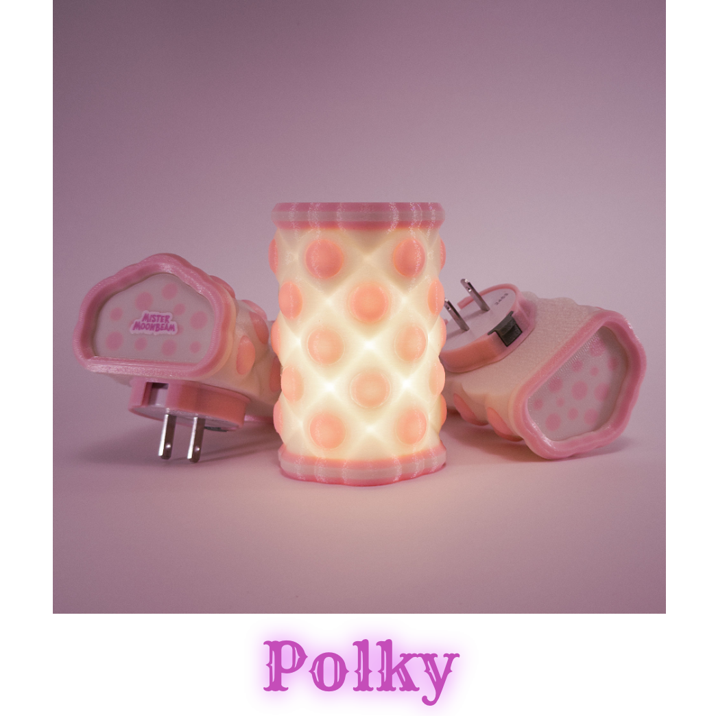 Three Polky night lights in pink, one glowing, with plug prongs visible