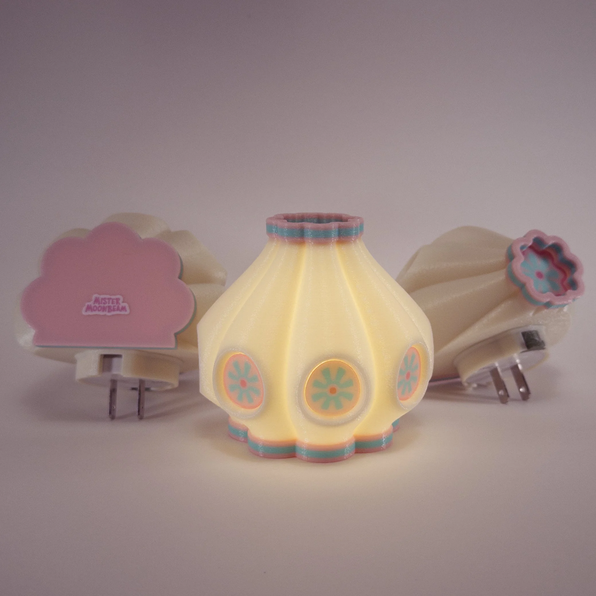 Three Garlic night lights in berry colors, glowing
