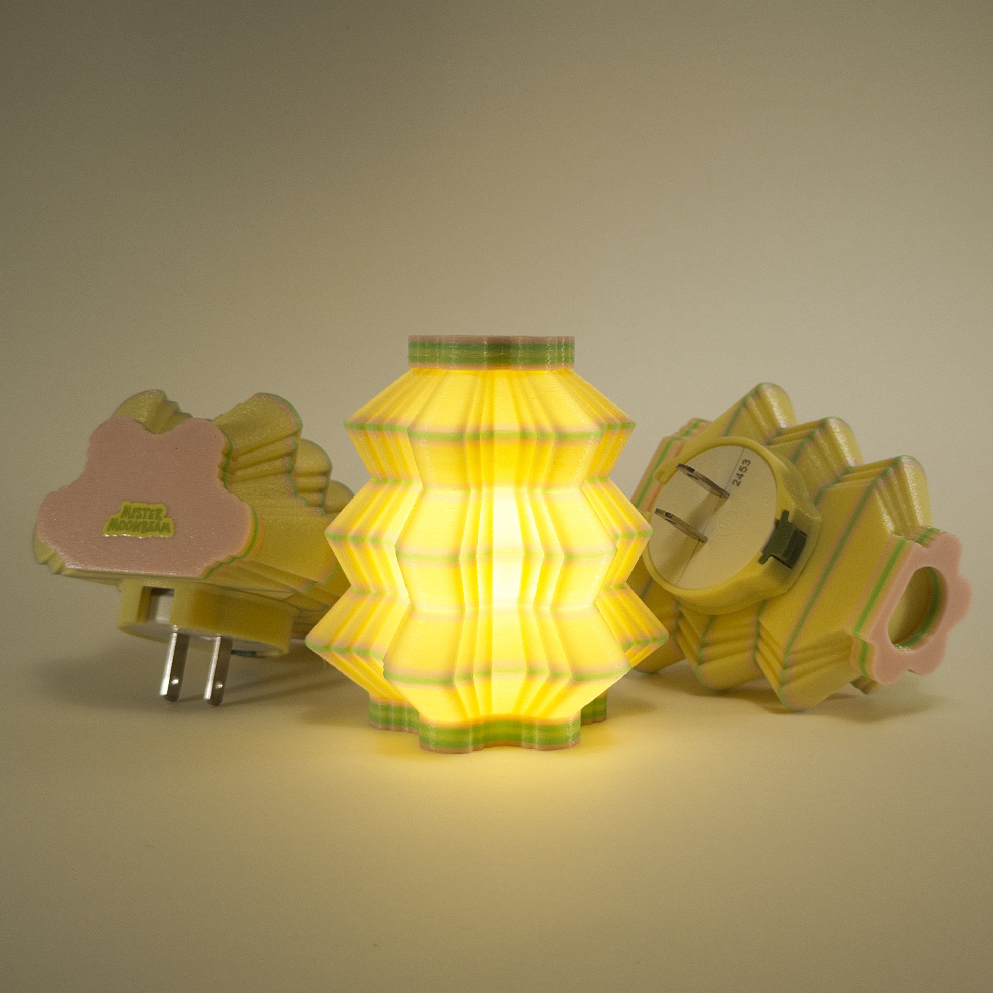 Three Scallops night lights in yellow, pink, and green, glowing