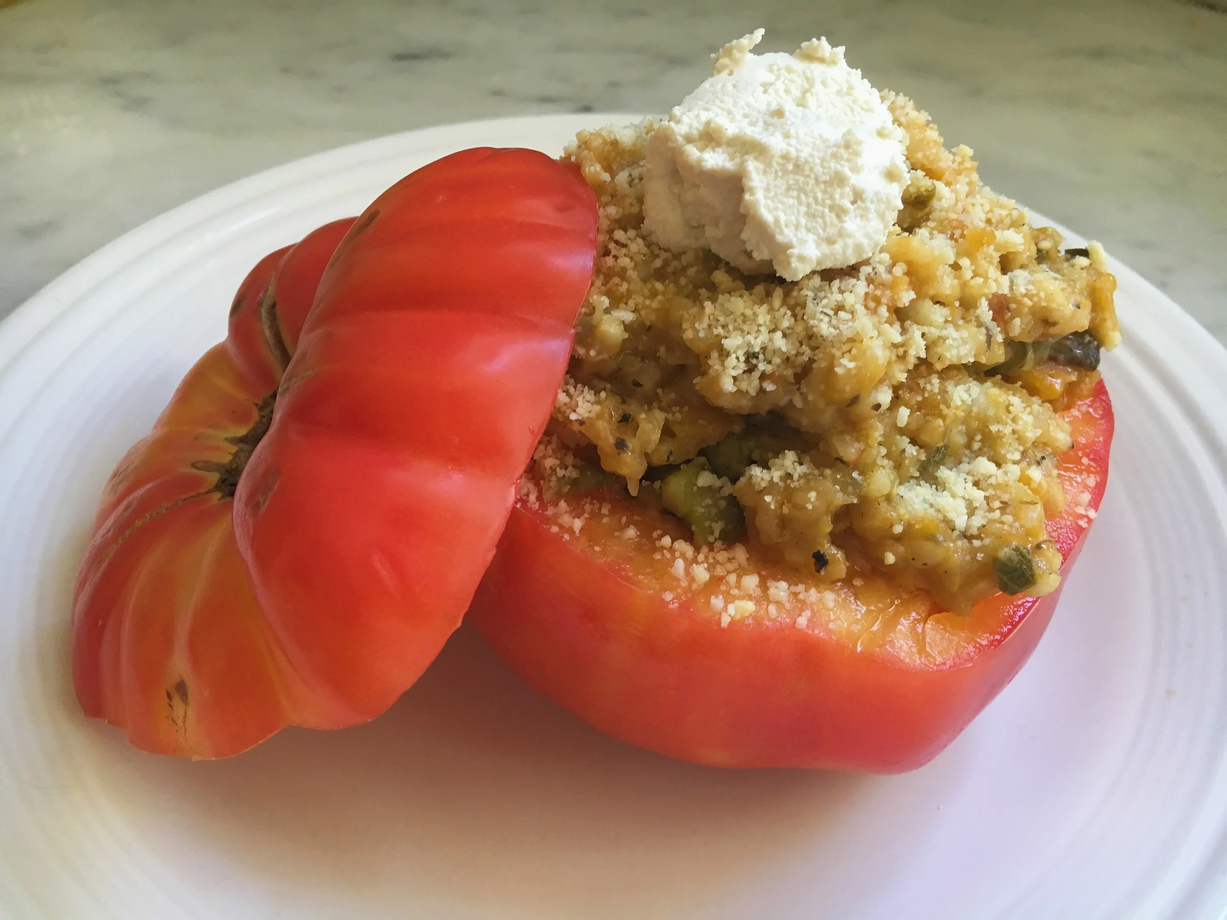 Fresh heirloom tomato stuffed with an asparagus, mushroom, summer squash risotto topped with homemade ricotta and parmesan. 