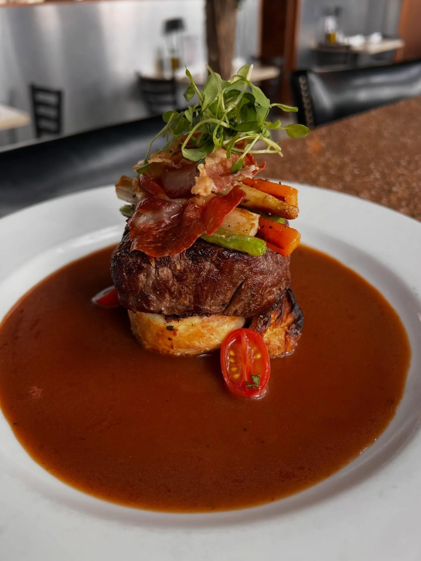 🥩Deconstructed Beef &ldquo;Wellington&rdquo;: A hard-seared filet mignon set atop crisp mushroom duxelle filled puff pastry, layered with roasted spring vegetables and finished with delicate prosciutto. Surrounded by a rich red wine demi-glace and g