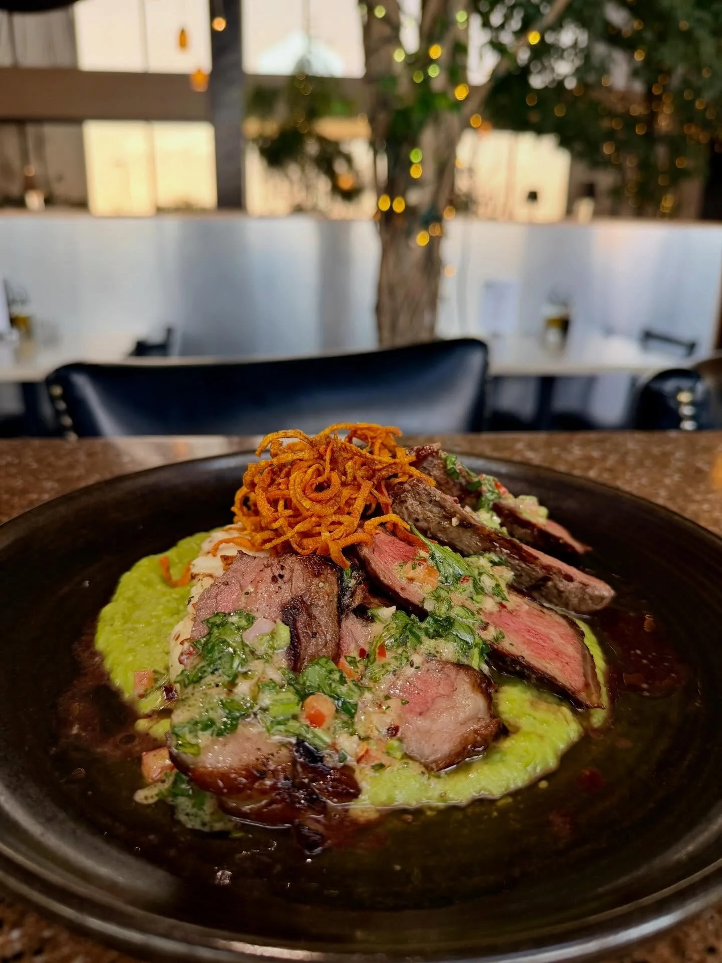 Chef Special: New York steak served over silky sweet pea pur&eacute;e with grilled cauliflower gratin, finished with mustard gremolata and crispy carrots.
