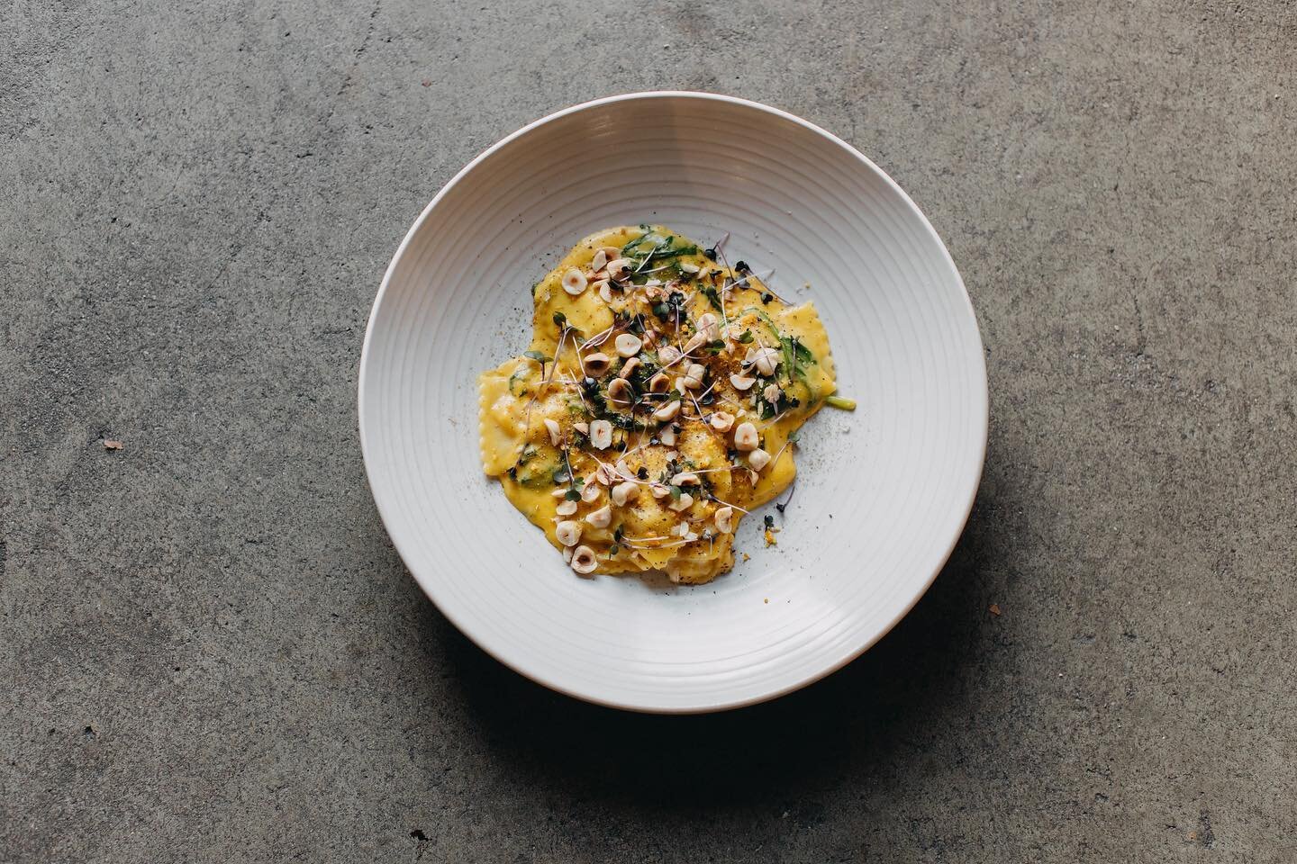 Pumpkin Ravioli with creamy saffron sauce, spinach, hazelnut, pepperberries, orange zest,
purple basil, smoked salt, and aniseed dust - @motherfremantle