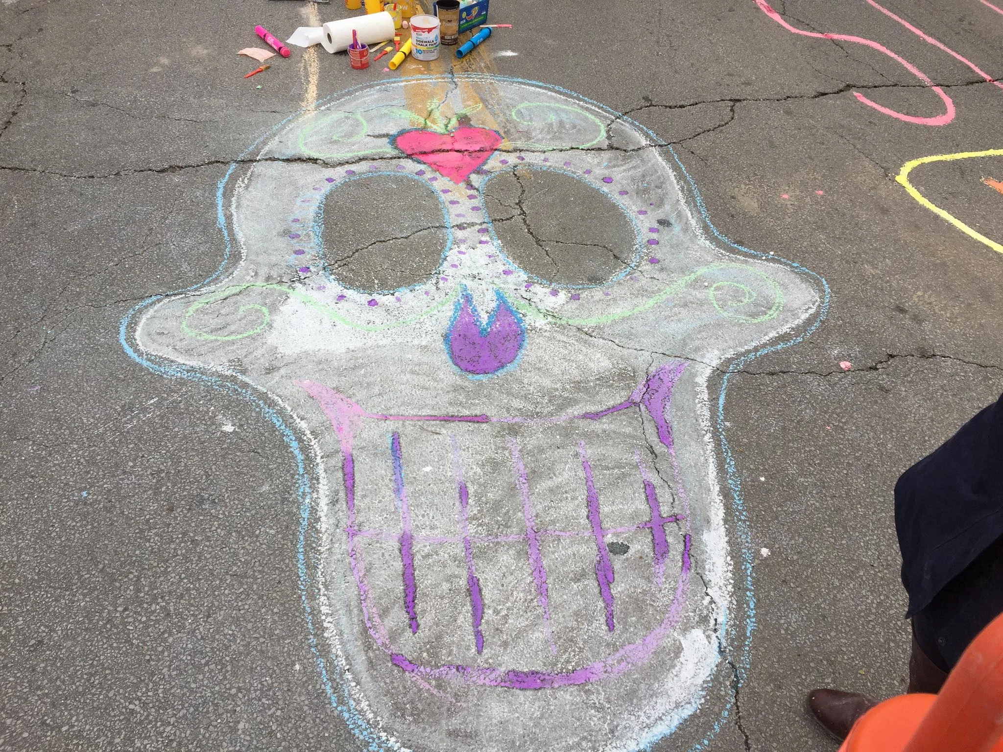 A calavera design chalked on the street on North Denver Avenue by organization Board Member and Living Arts of Tulsa artist Mery McNett as part of "Chalk the Walk." (Photo © 2017 Brian Parker)