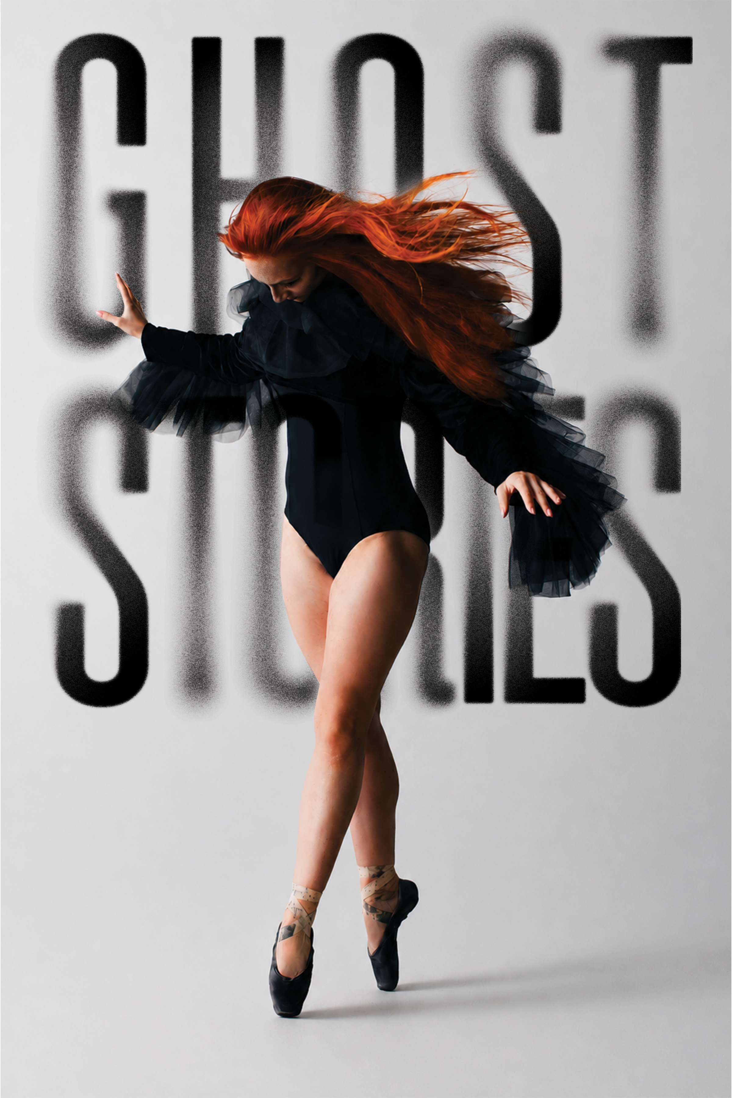 Ballet Des Moines dancer Megan Boyette stands eerily in black pointe shoes, in a stark black leotard with black ruffled sleeves, reminiscent of a raven. Her hair is bright red, blown back by the wind. Shot by Jami Milne in 2026