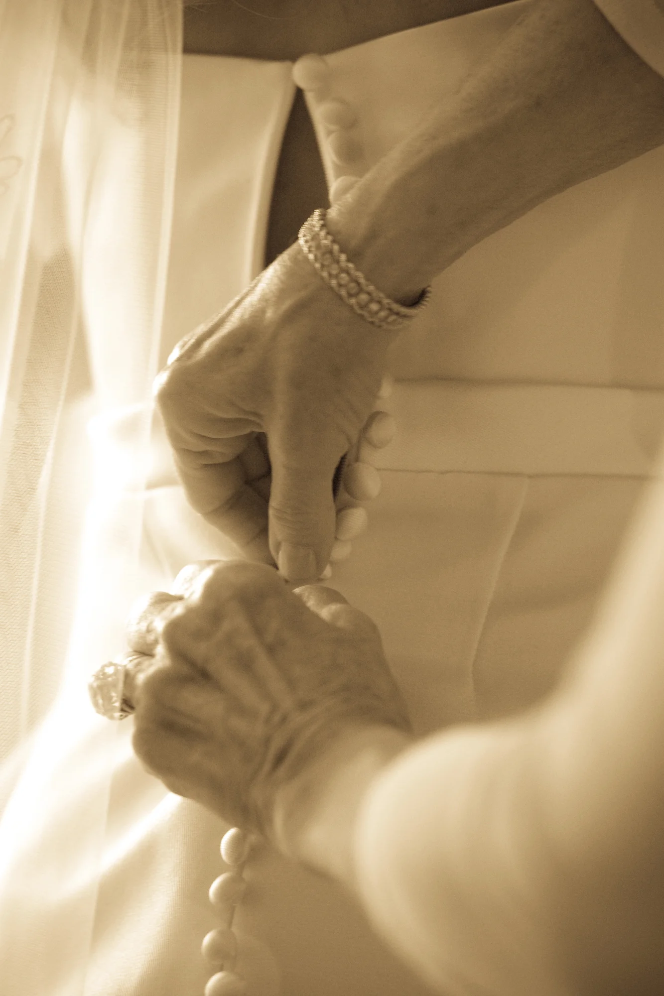 A great detail shot of my mom fastening me into my dress.