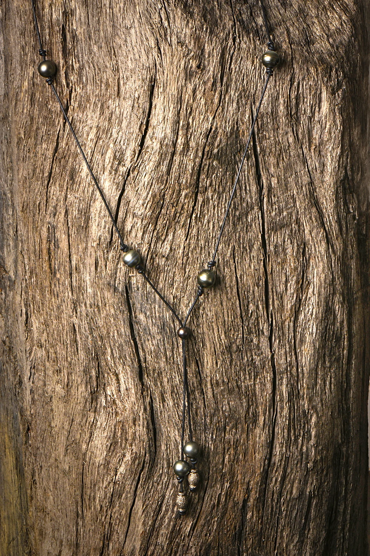 SIMPLE BLACK LARIAT WITH BARRELS FULL.JPG