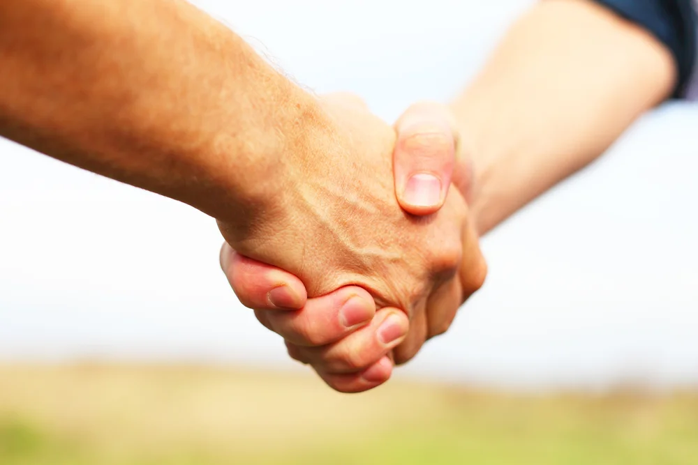 stock-photo-close-up-of-business-people-shaking-hands-to-confirm-their-partnership-124151659.jpg