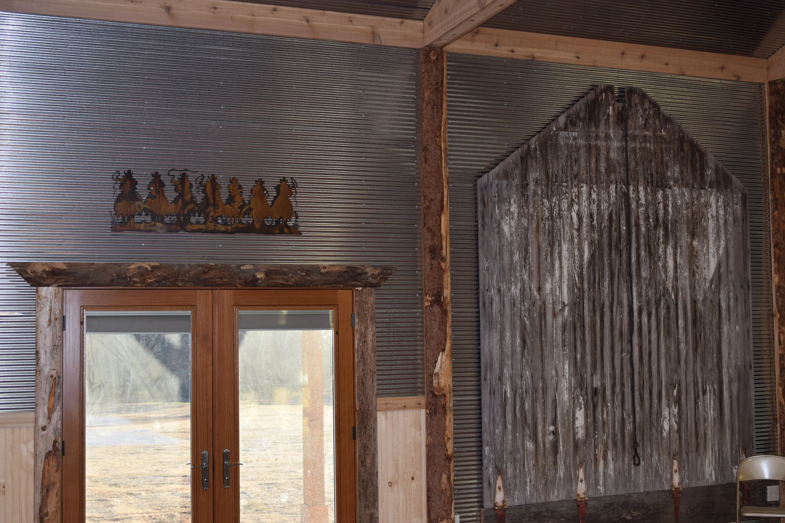 Interior of event center-East wall The old hayloft door is one of the few things we preserved from our homestead barn "over west" prior to the Anderson Creek Fire