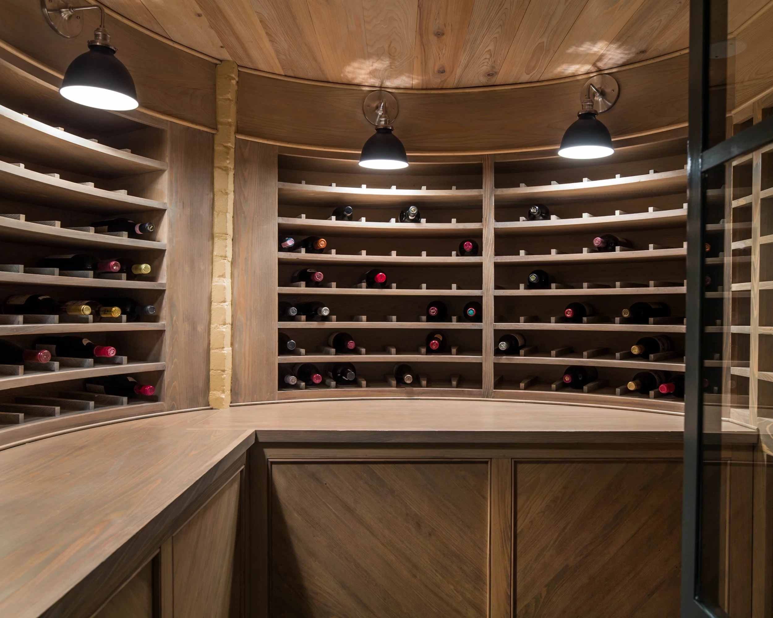 Wine cellar fabricated by Deal Cabinets in an expansive basement remodel designed by Sissy Austin, AIA.