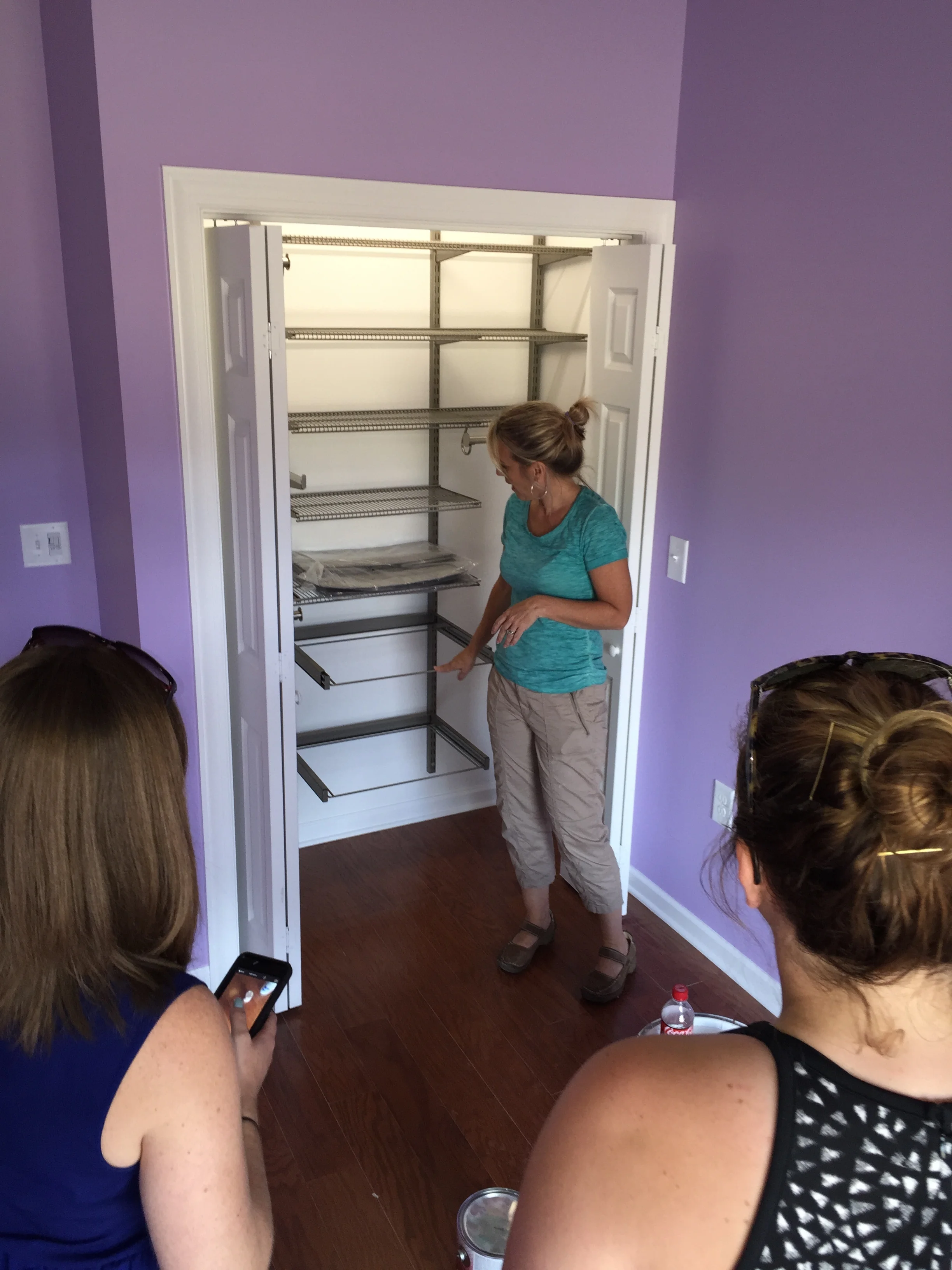 Kim McBrayer, owner of spacecadetsorganizing.com, demonstrating one of many of the closet systems she donated to the hfotusa.org in Calera, AL.