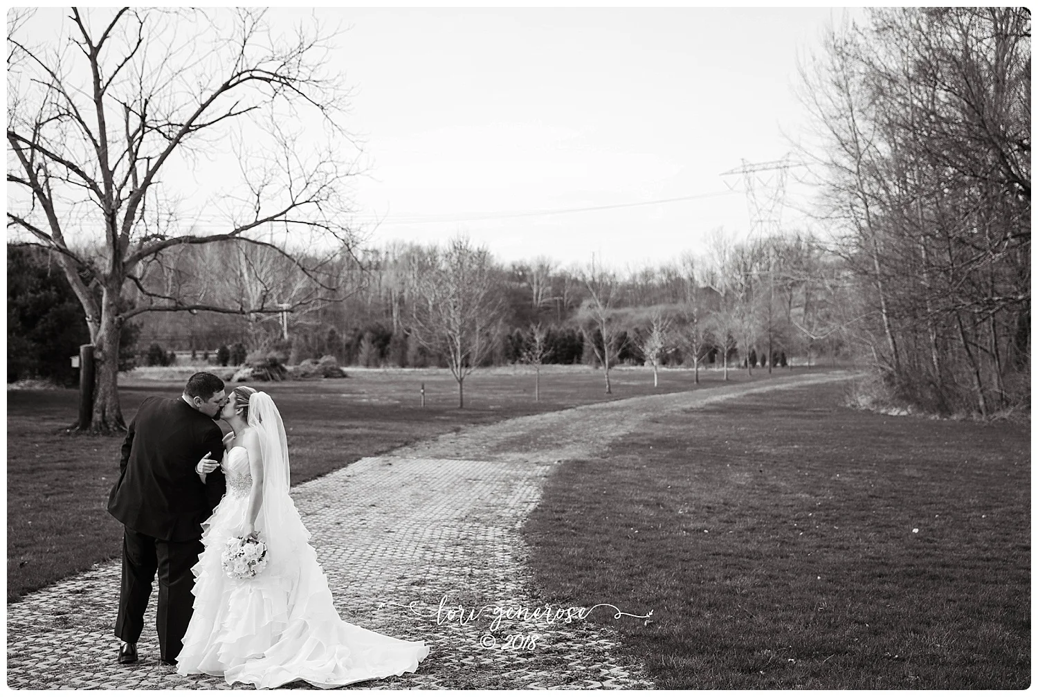 brideandgroomwalkingblackandwhiteatkreidersvillecoveredbridgenorthamptonpalgphotography.jpg