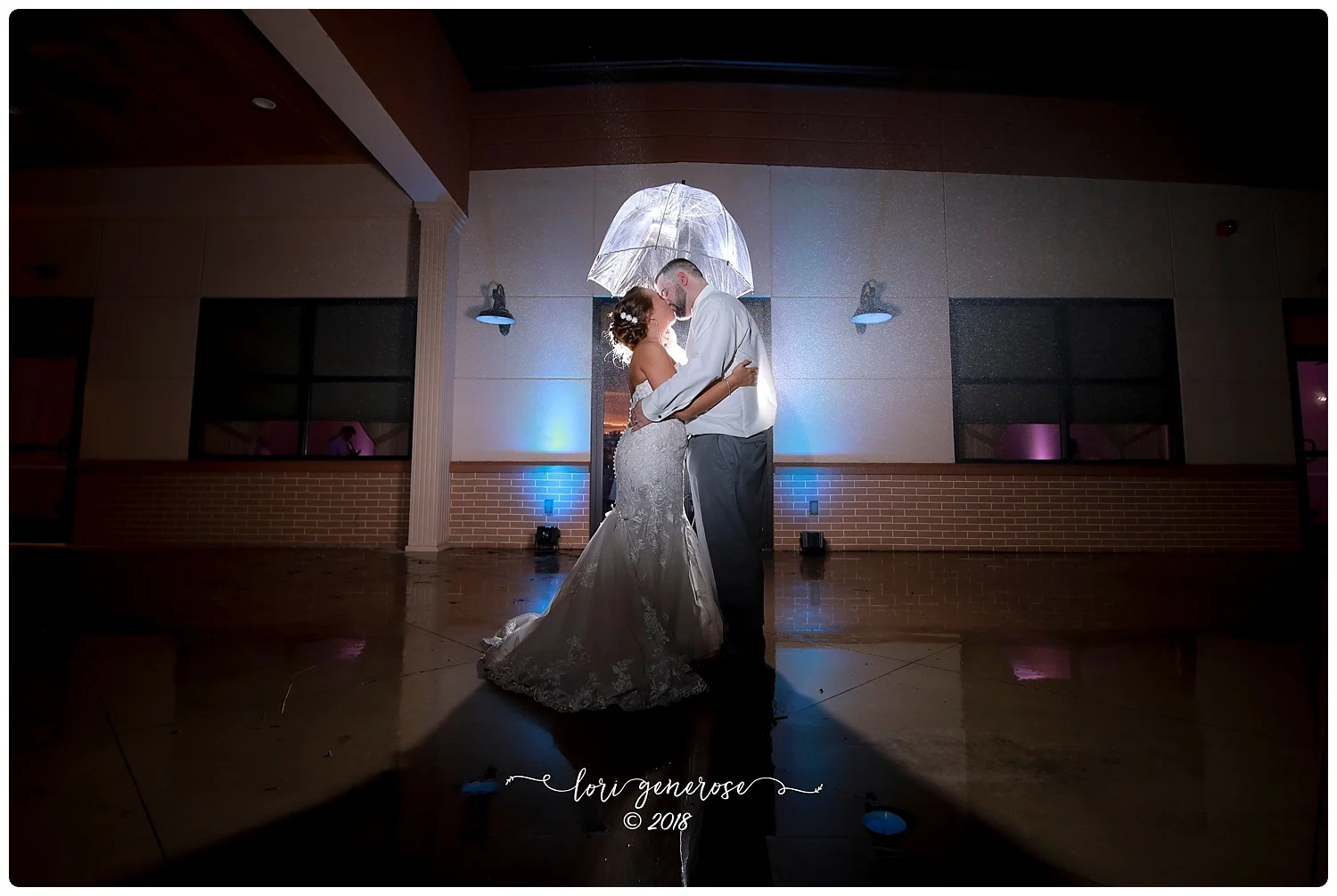lgphotographylorigeneroseweddingreceptioncapriottismcadoopabrideandgroomwithumbrellaatnightshotrainydaywedding.jpg