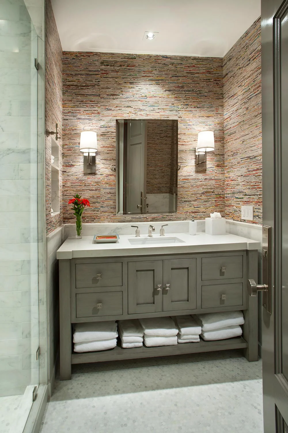 The guest bath would be used mostly by children and grand children, so the space was intended to be both functional and whimsical. The wallpaper is upcycled magazine pages stitched together into single sheets. 