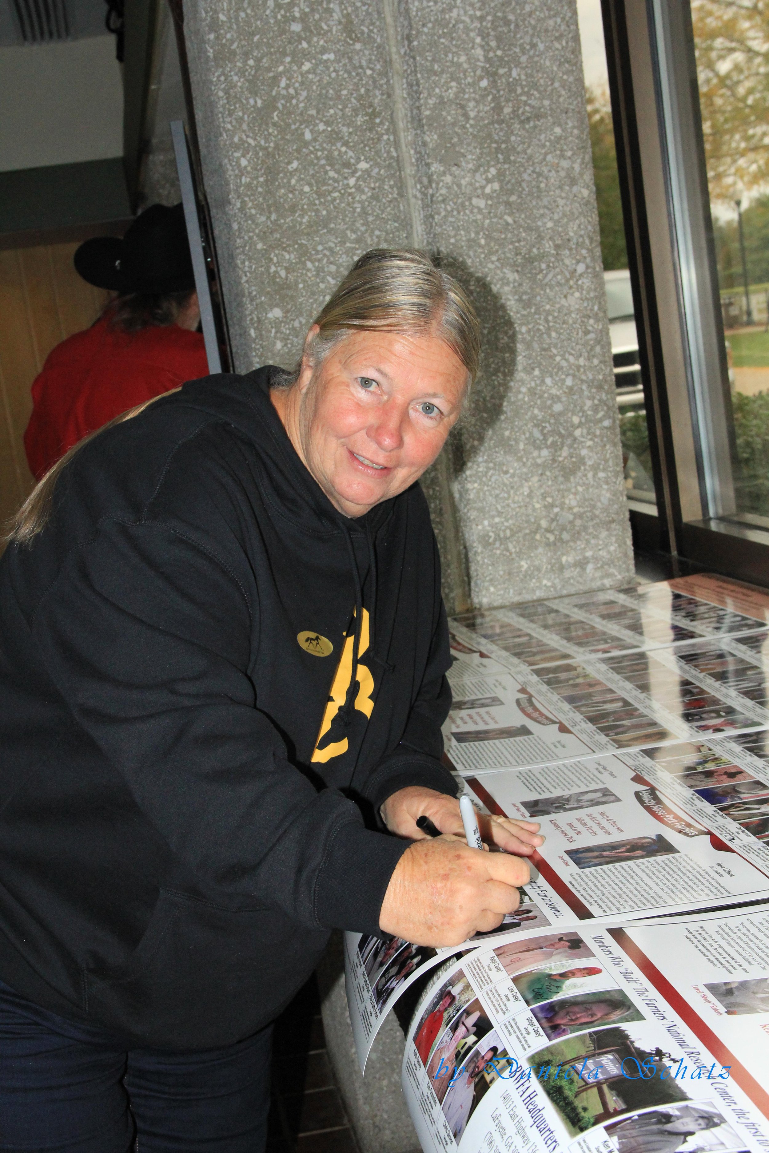 Kathy Fortner, signing the 2013 Hall of Fame Posters as a fellow member inducted in 2005..JPG