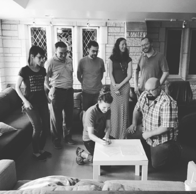 Staff and Elders signing the building use covenant with Ashley, Pastor at Kindred