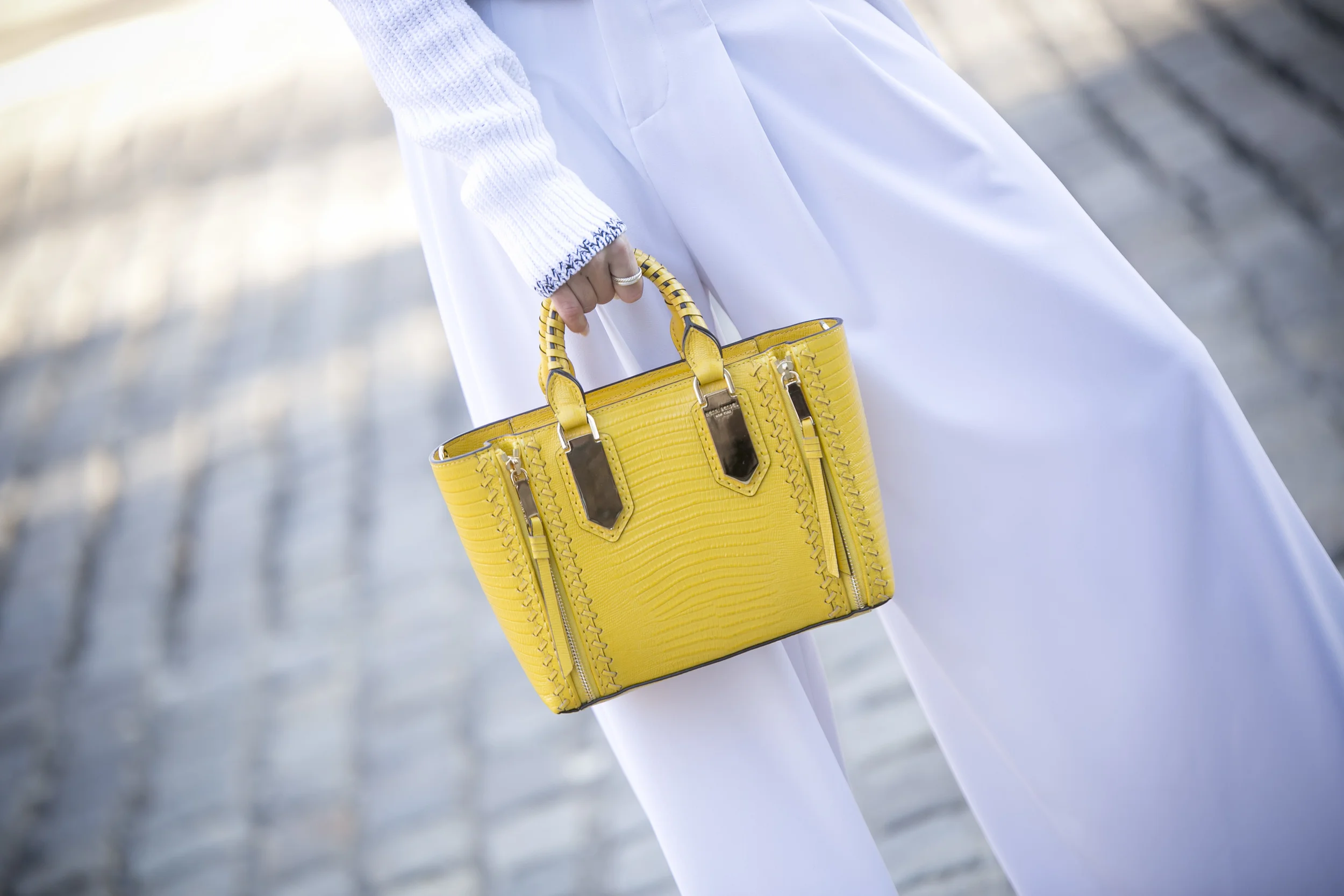 Sweater: Rag&Bone |Pants: Alice&Olivia |Bag: Henri Bendel |Belt: B-Low the Belt Dino Petrocelli Photography
Normal
0
false
false
false
EN-US
JA
X-NONE
/* Style Definitions */
table.MsoNormalTable
{mso-style-name:"Table Normal";
mso-tstyle-rowband-size:0;
mso-tstyle-colband-size:0;
mso-style-noshow:yes;
mso-style-priority:99;
mso-style-parent:"";
mso-padding-alt:0in 5.4pt 0in 5.4pt;
mso-para-margin:0in;
mso-para-margin-bottom:.0001pt;
mso-pagination:widow-orphan;
font-size:12.0pt;
font-family:Cambria;
mso-ascii-font-family:Cambria;
mso-ascii-theme-font:minor-latin;
mso-hansi-font-family:Cambria;
mso-hansi-theme-font:minor-latin;}
Hey Everyone!! I finally shot a bunch of new looks on Friday and I cannot wait to share them all with you! I gave today’s white look a modern twist with a black leather choker and my new favorite belt from B-Low the belt(a current must have!) If you are ever looking for a great pair of wide-leg pants…check out Alice & Olivia. I now have a pair of these trousers in white, black, and orange. They are great and I love the fluid movement of them. For accessories I added my calf-hair booties and my new yellow mini croc bag from Henri Bendel. I am loving the unexpected pop of yellow mixed with the spotted print…so fierce! This bag also comes with an optional crossbody strap so it is perfect for busy summer days running around the city. I added the links to this look below along with some other amazing options. Thanks for stopping by!! Have a great week!!