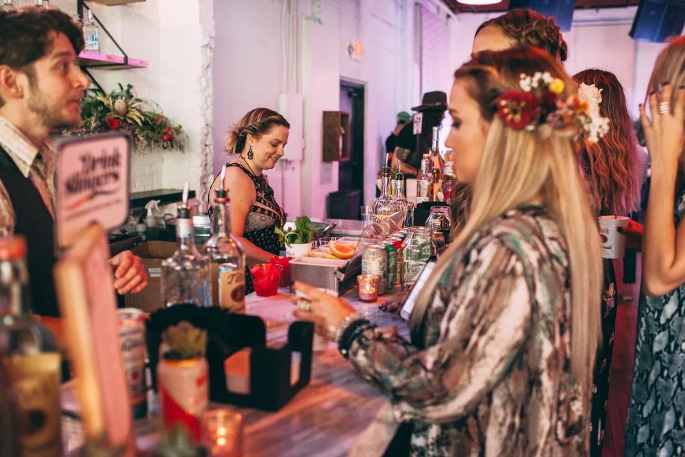 Guests crowding the bar at an evening party