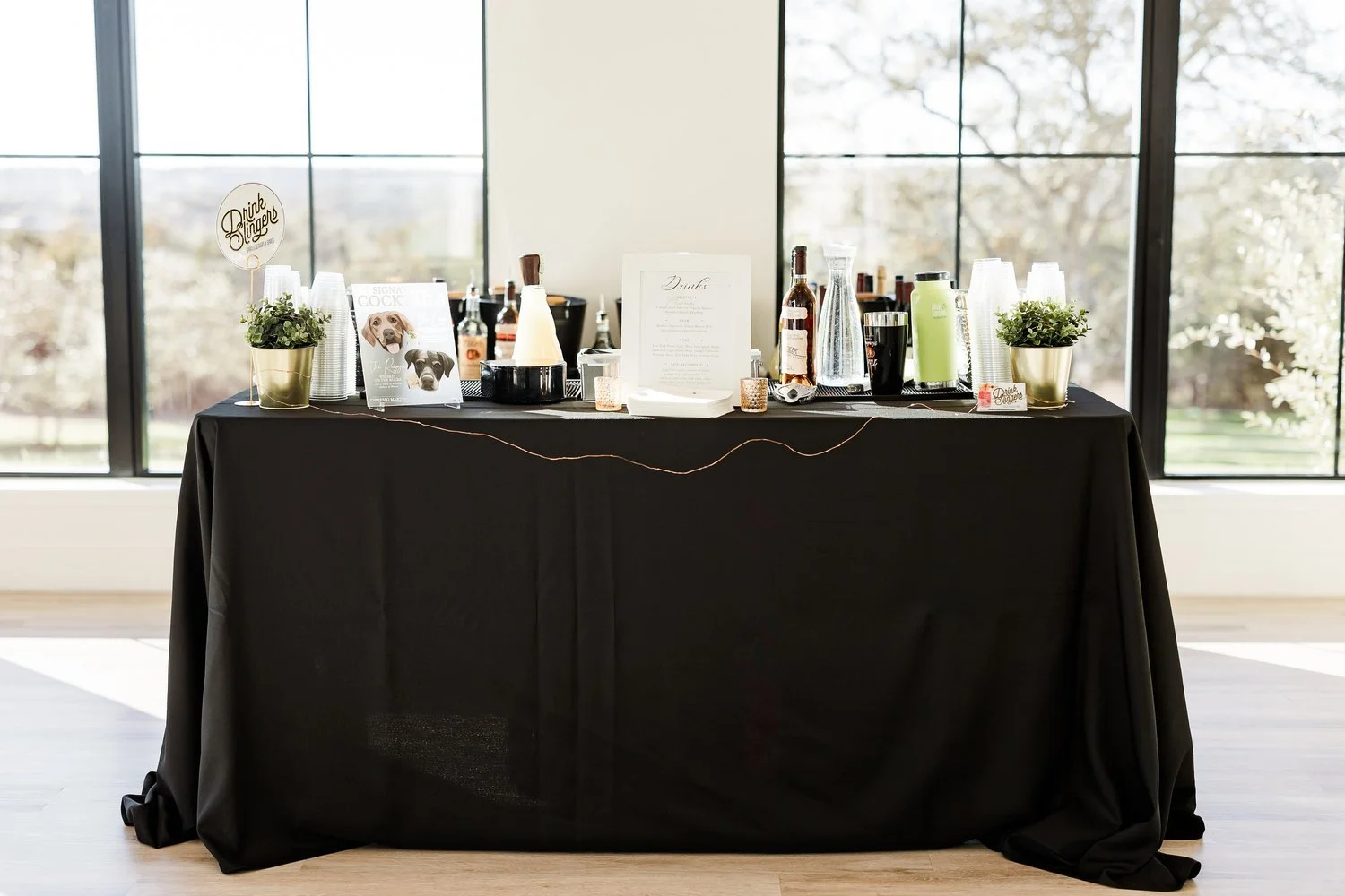 A Drink Slingers bar set up with spirits, mixers and glassware ready for guests