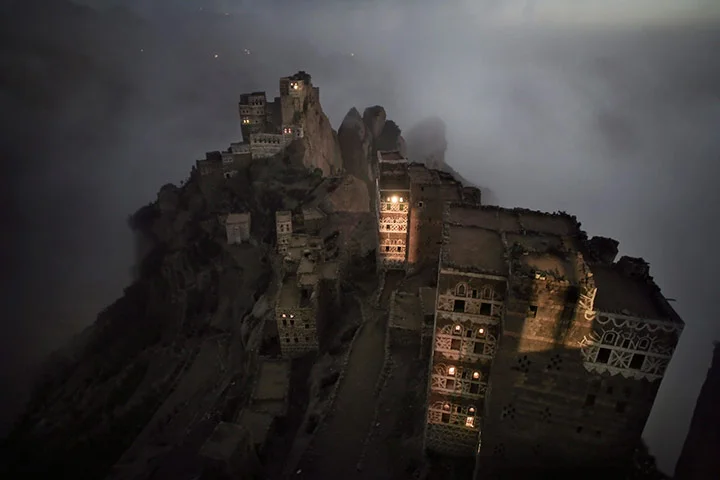 mabelmoments:
“This was shot just after a sunset on the roof of a palace at Shugruf village in the Haraz Mountains of Yemen. No extra lighting was used. The sun has just set (see the top right corner of the image) and mist has started to rise from …