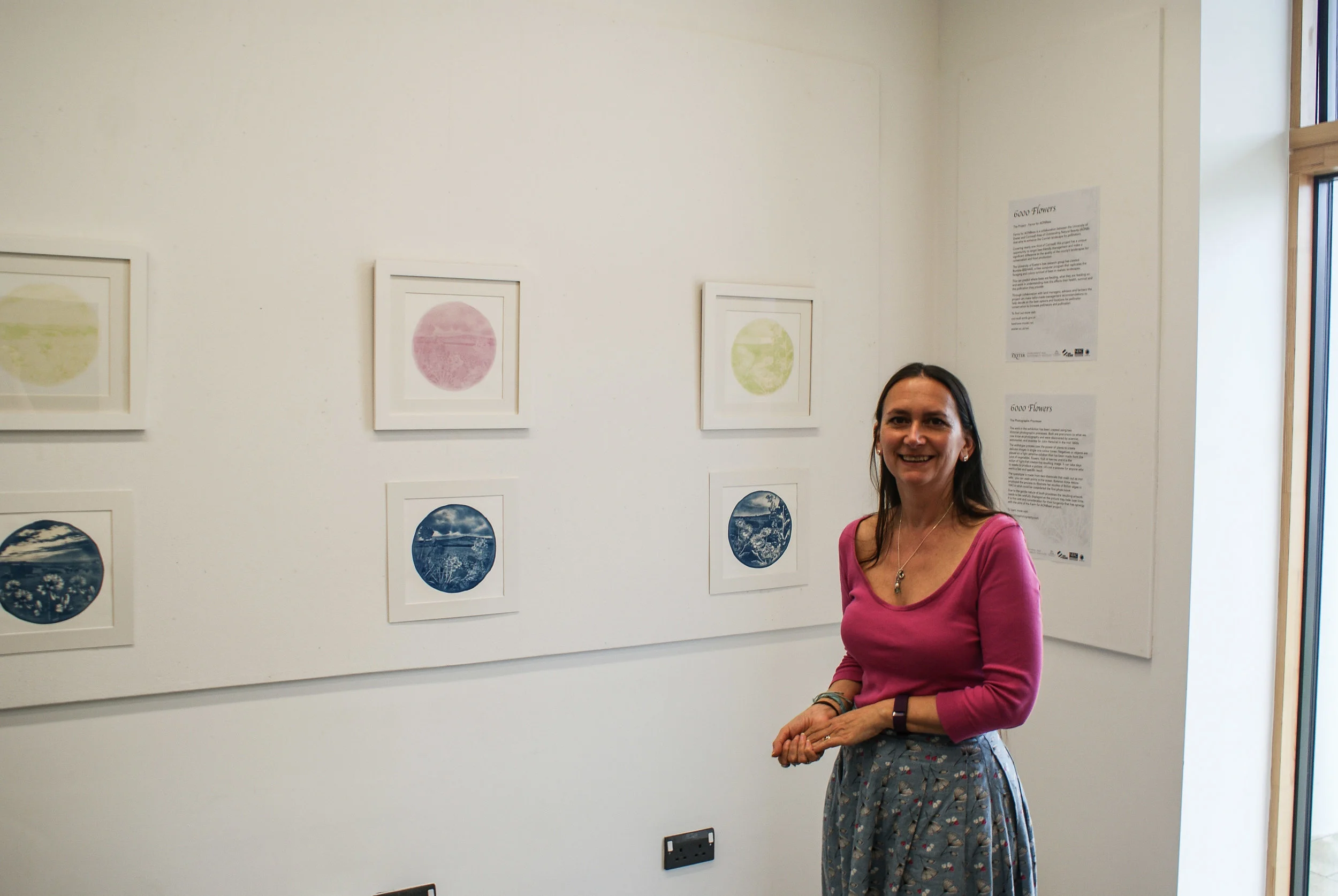 Artist Josie Purcell alongside some of her work for 6000 Flowers