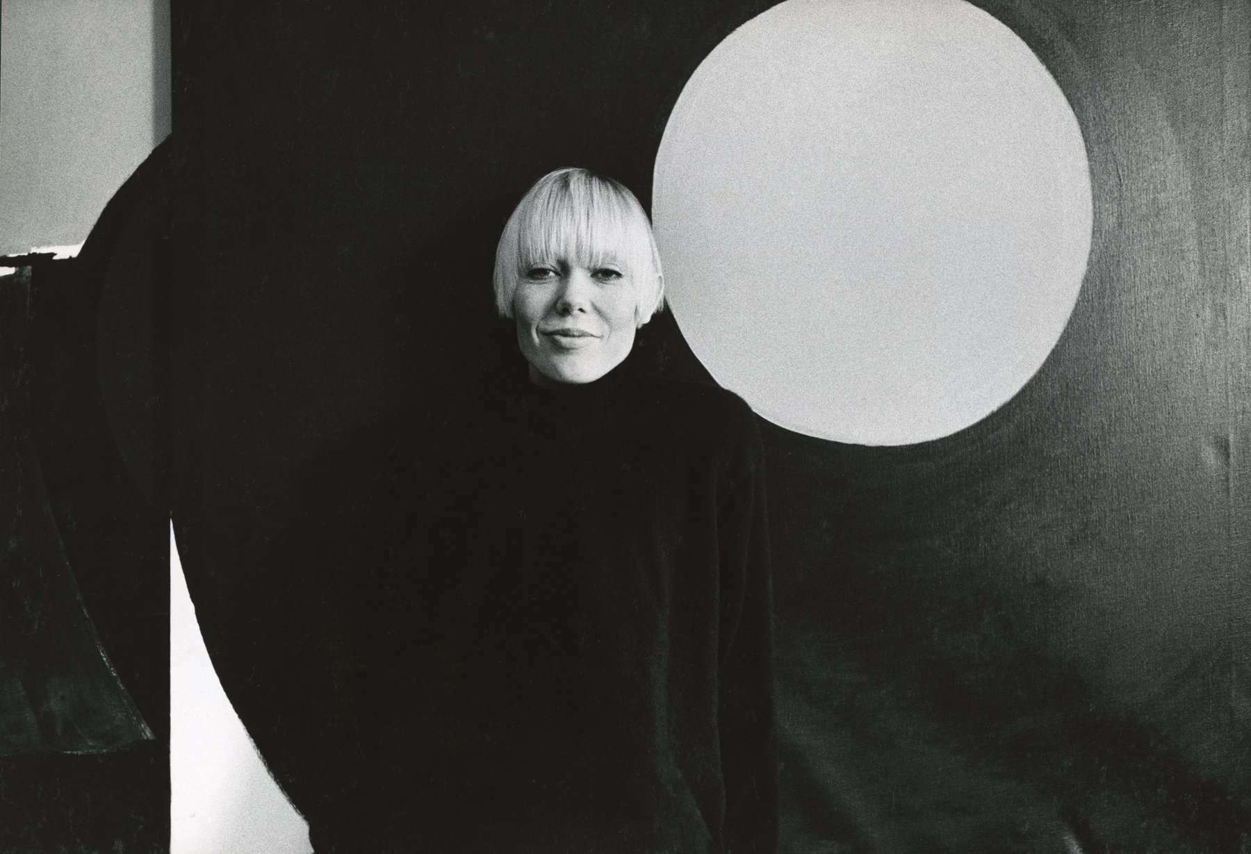Iria Leino photographed in 1969 in front of the painting The Red Moon