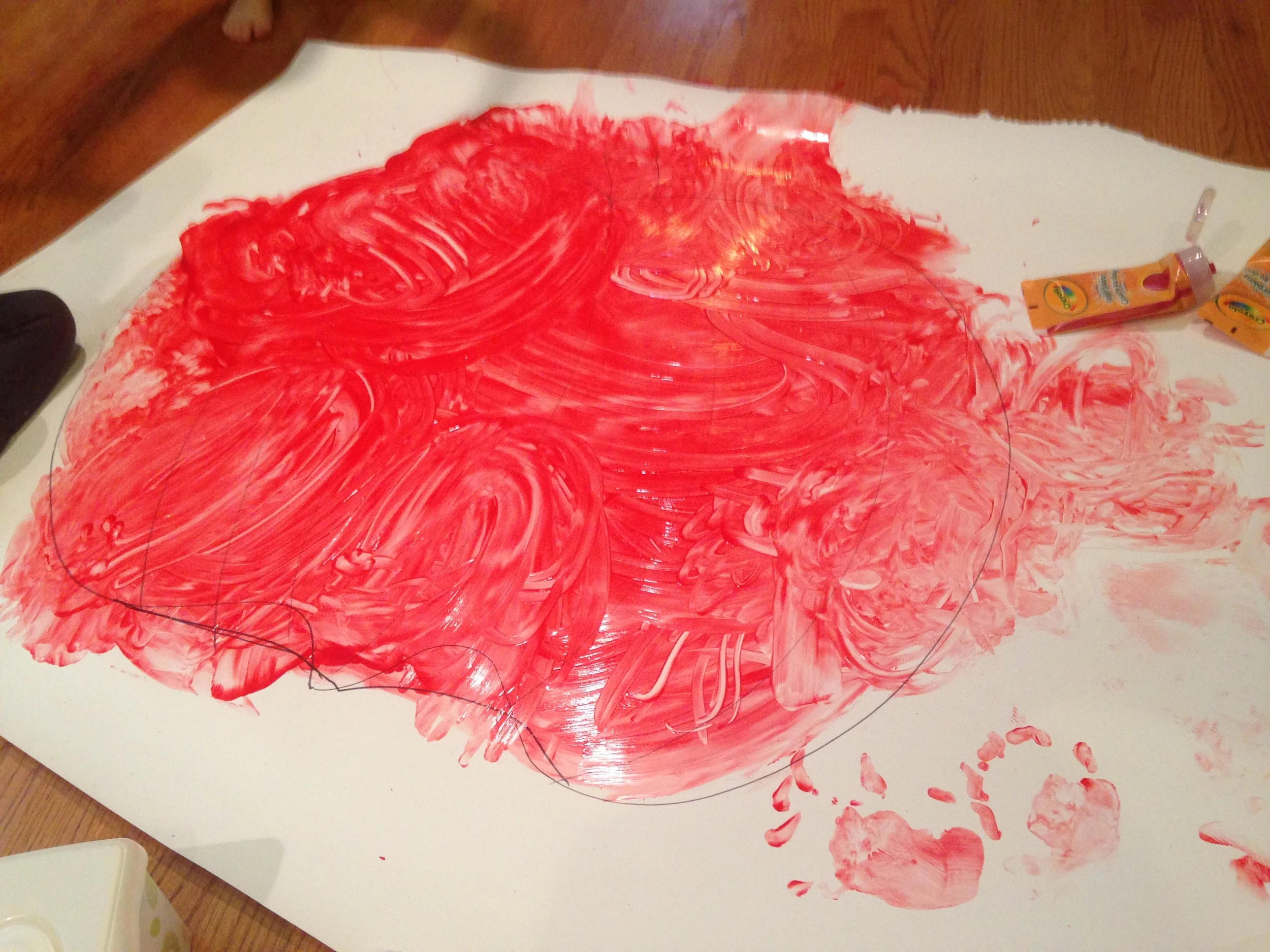 Finger painting a large pumpkin