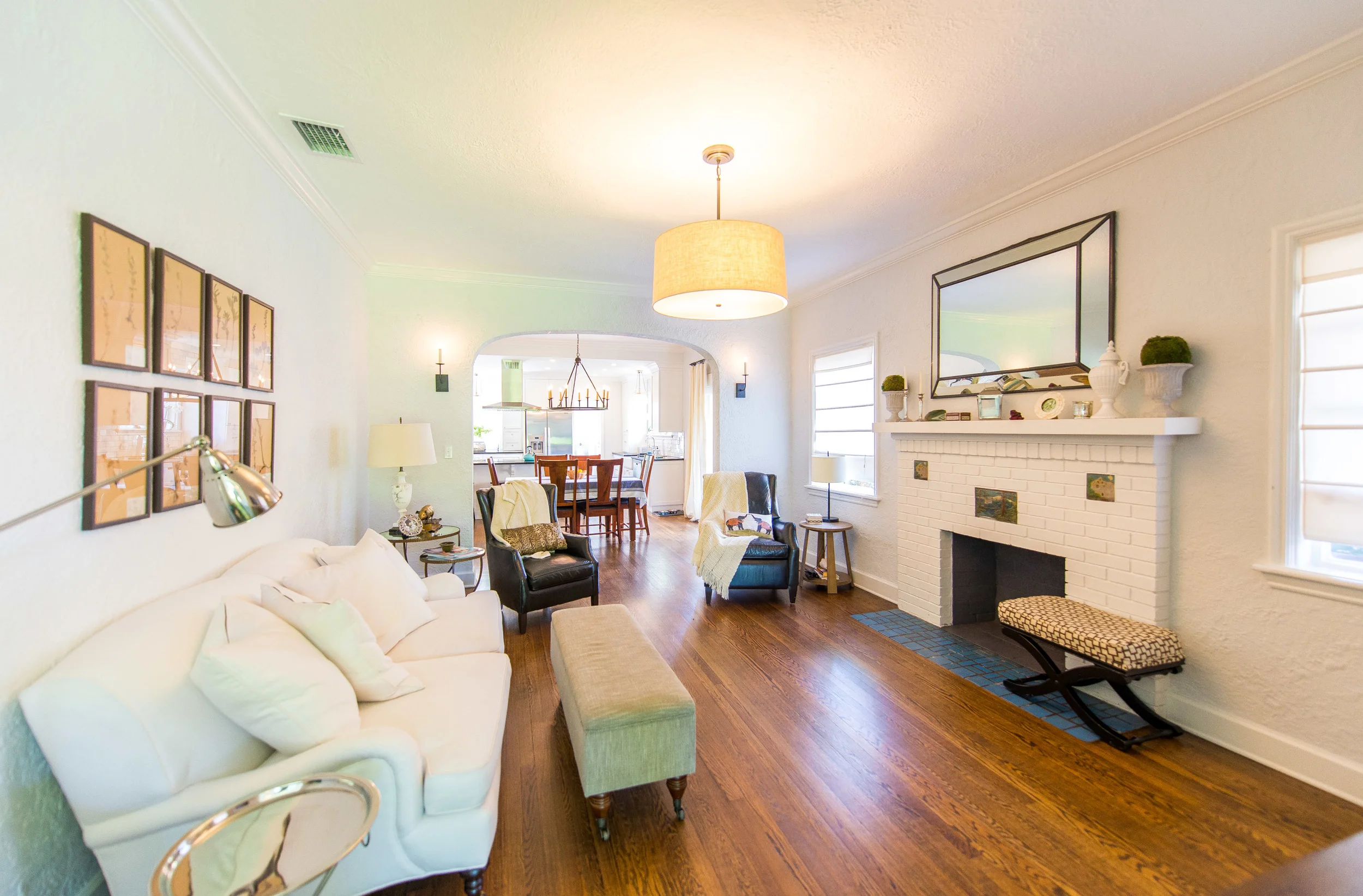 Beautiful and bright living room complete with a fireplace.