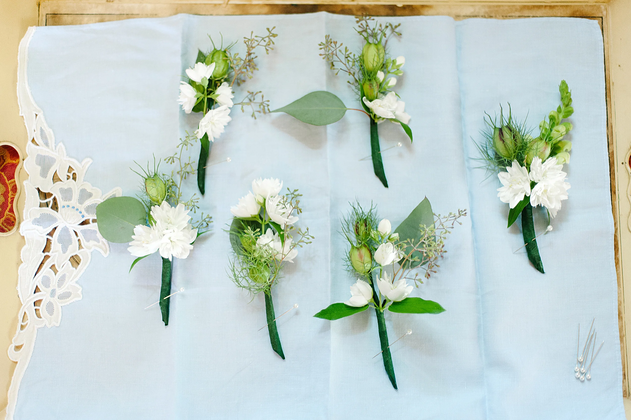 Boutonnieres featured Nigella, fragrant mock orange, and seeded eucalyptus. 