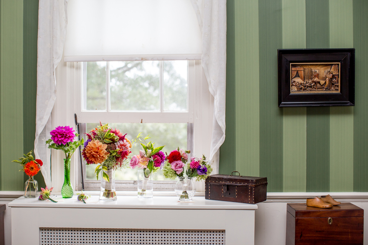 flowers in vases in front of window