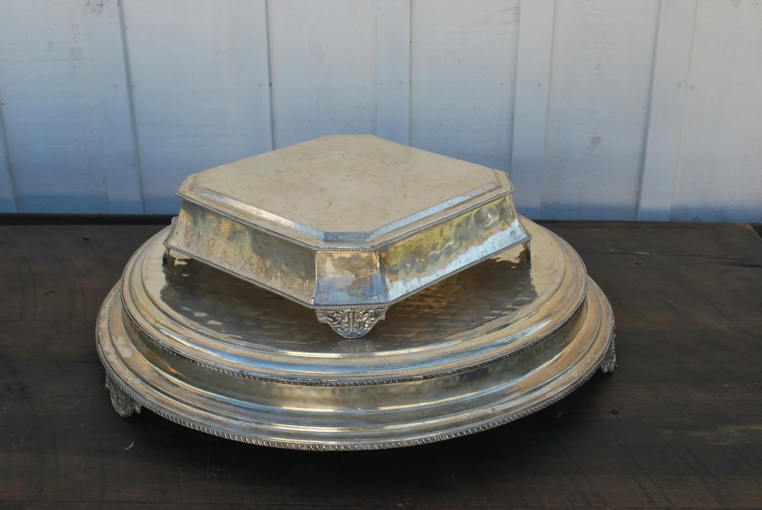 Silver Cake Stands $15 each, 3 available. The largest is 22" on the top and 27" across bottom. The other is 12" across the top and 15 1/2" across the bottom. One more available - see picture.