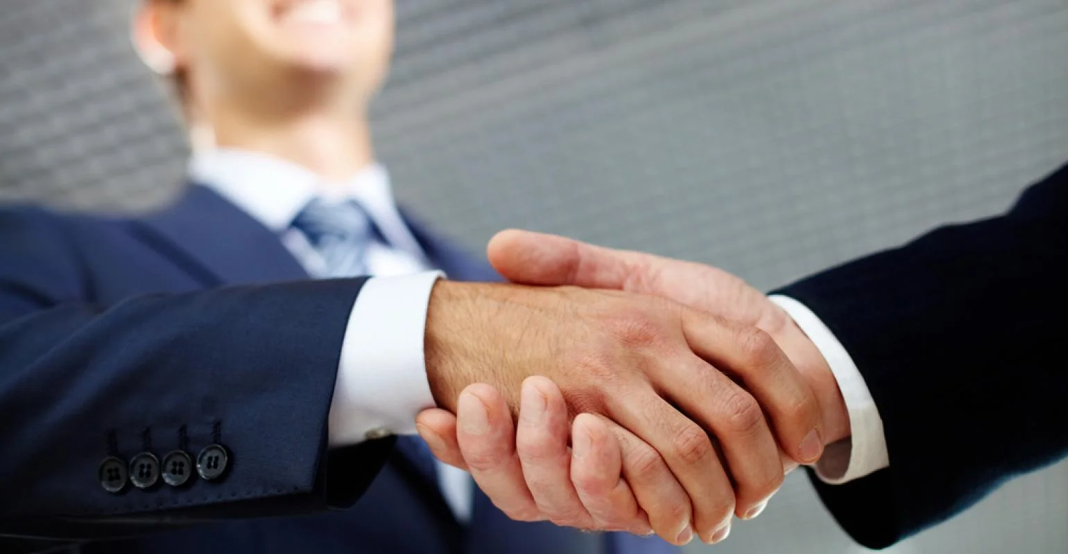 Two businessman shaking hands greeting each other_0.jpg
