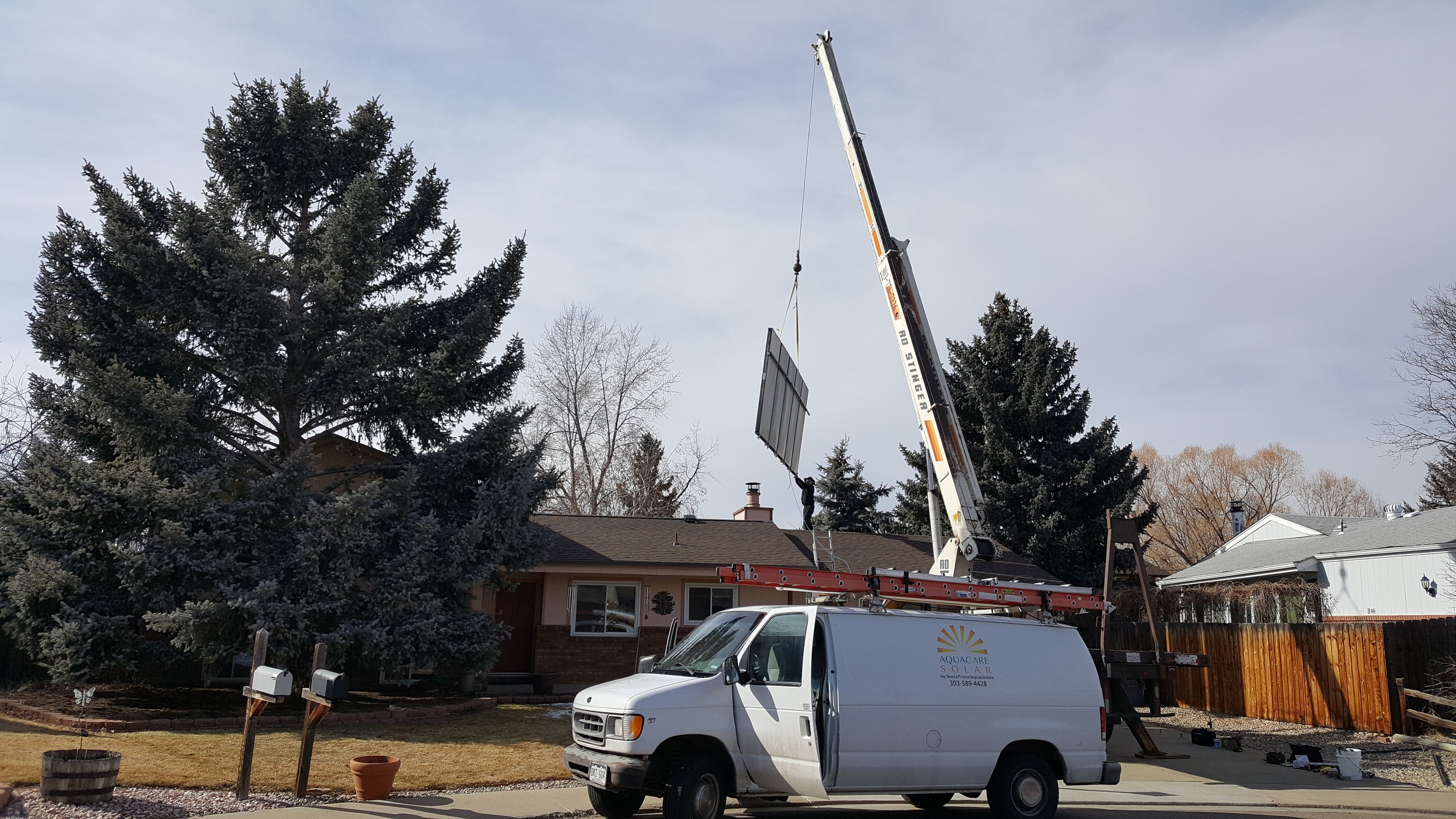 Crane reinstall of new solar thermal panels