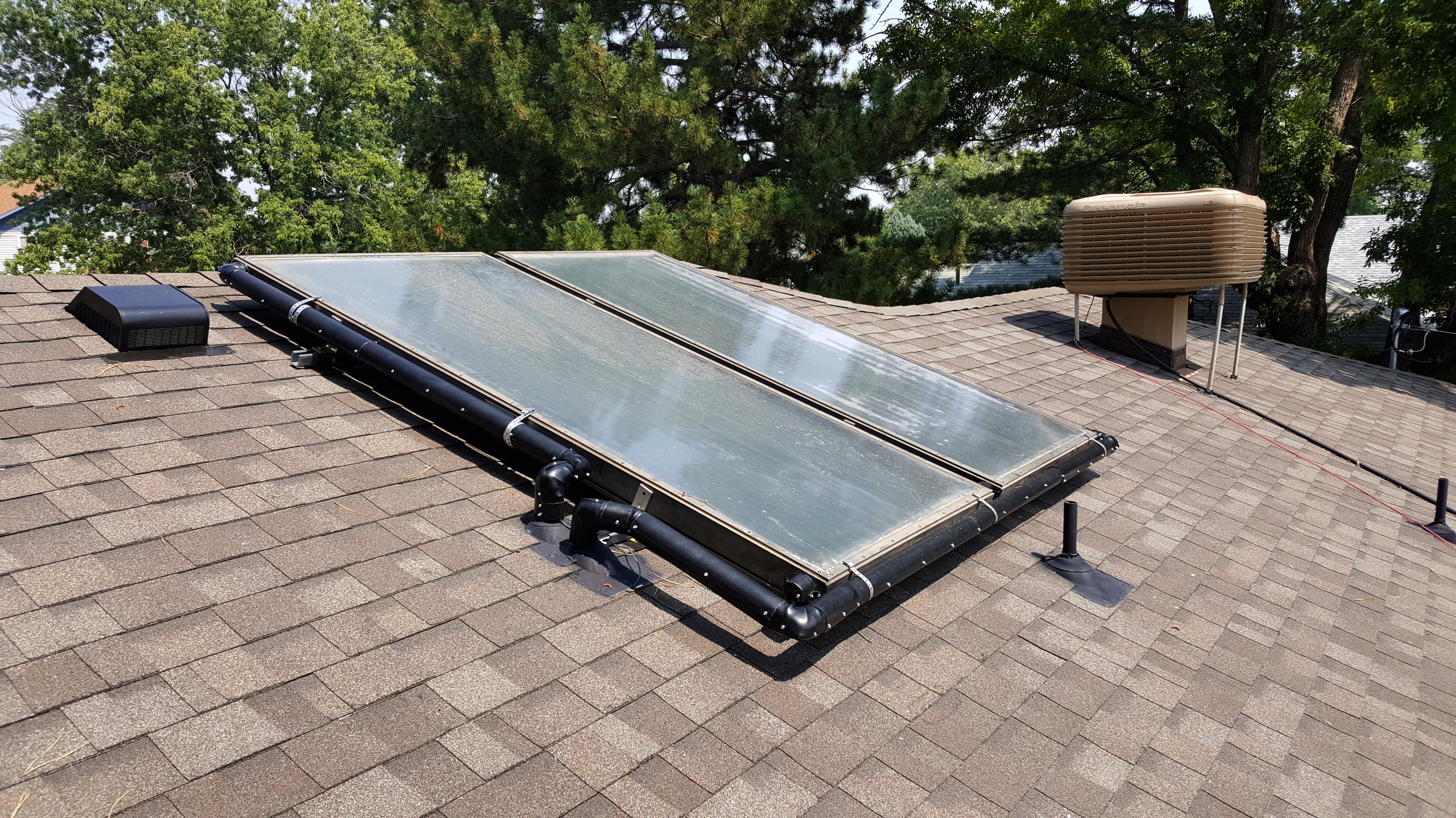 Two flush mounted solar thermal panels after there was roof repair due to a hail storm in Lafayette, Colorado