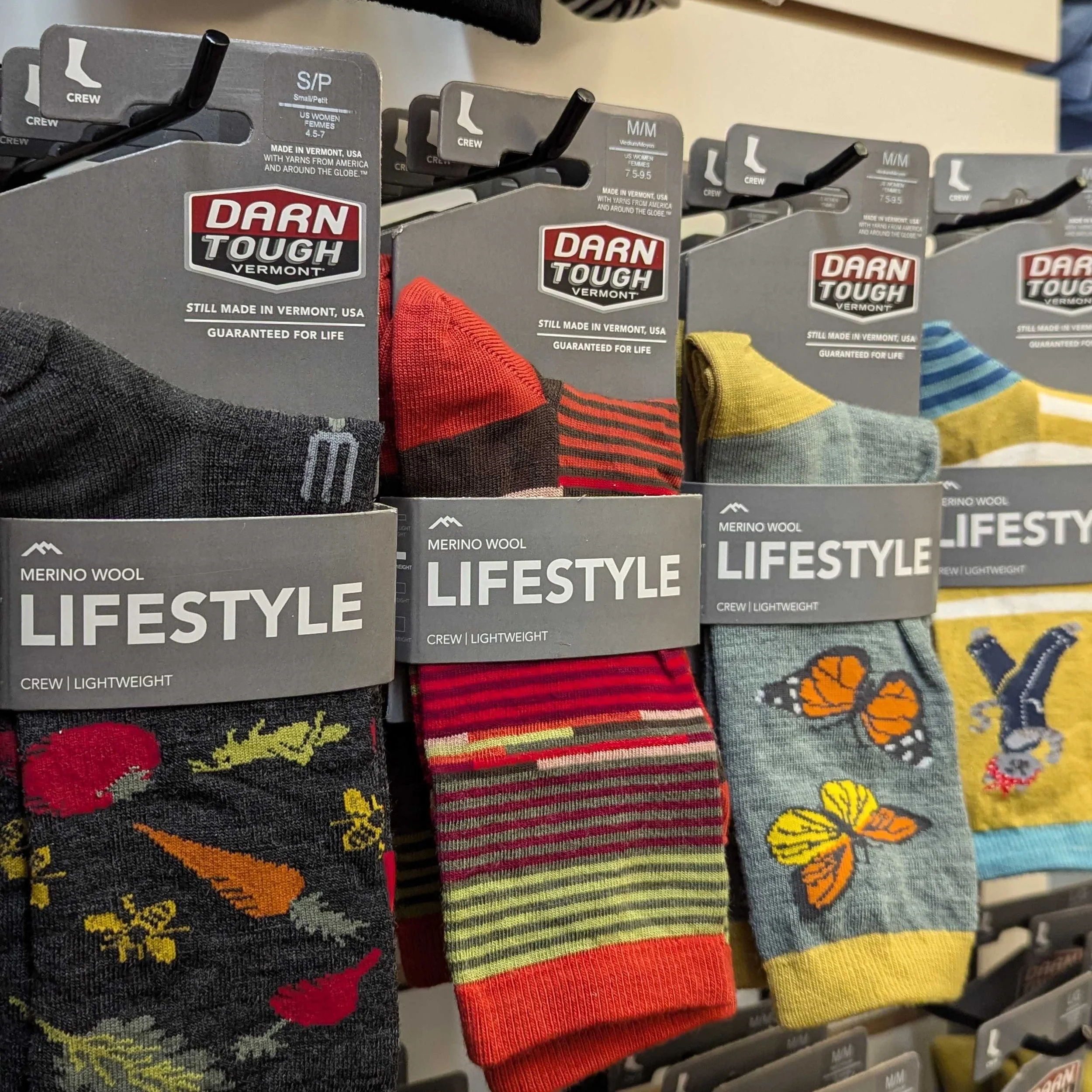 Darn Tough display at Hide & Sole. Made in Vermont, USA. Designed to be fun, durable, and comfortable. Socks are colorful and patterned. Backed by a lifetime warranty.