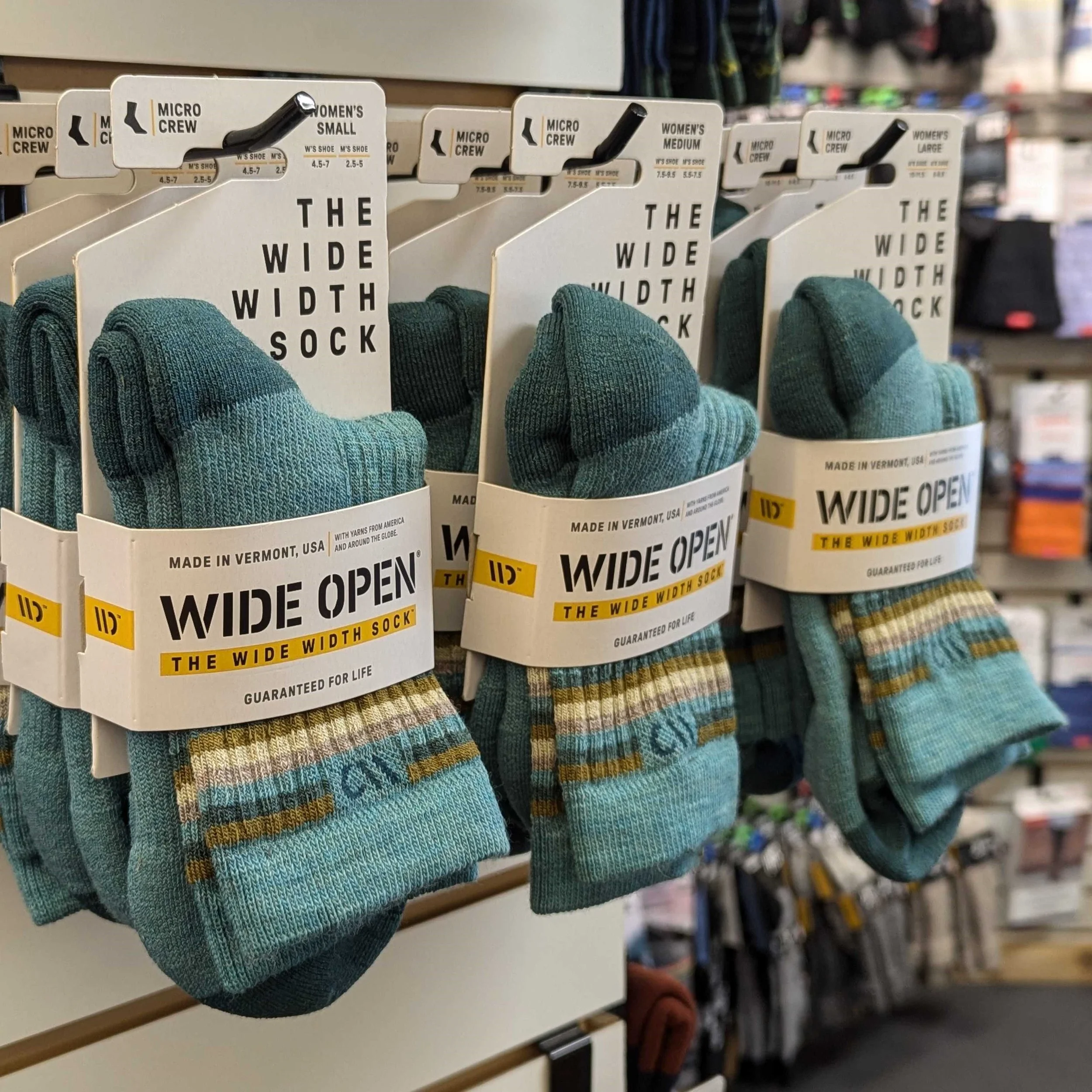 Wide Open sock display at Hide & Sole. Soft wool socks designed for wide feet, calves, and ankles. Made in Vermont, USA by Darn Tough and backed with a lifetime warranty.