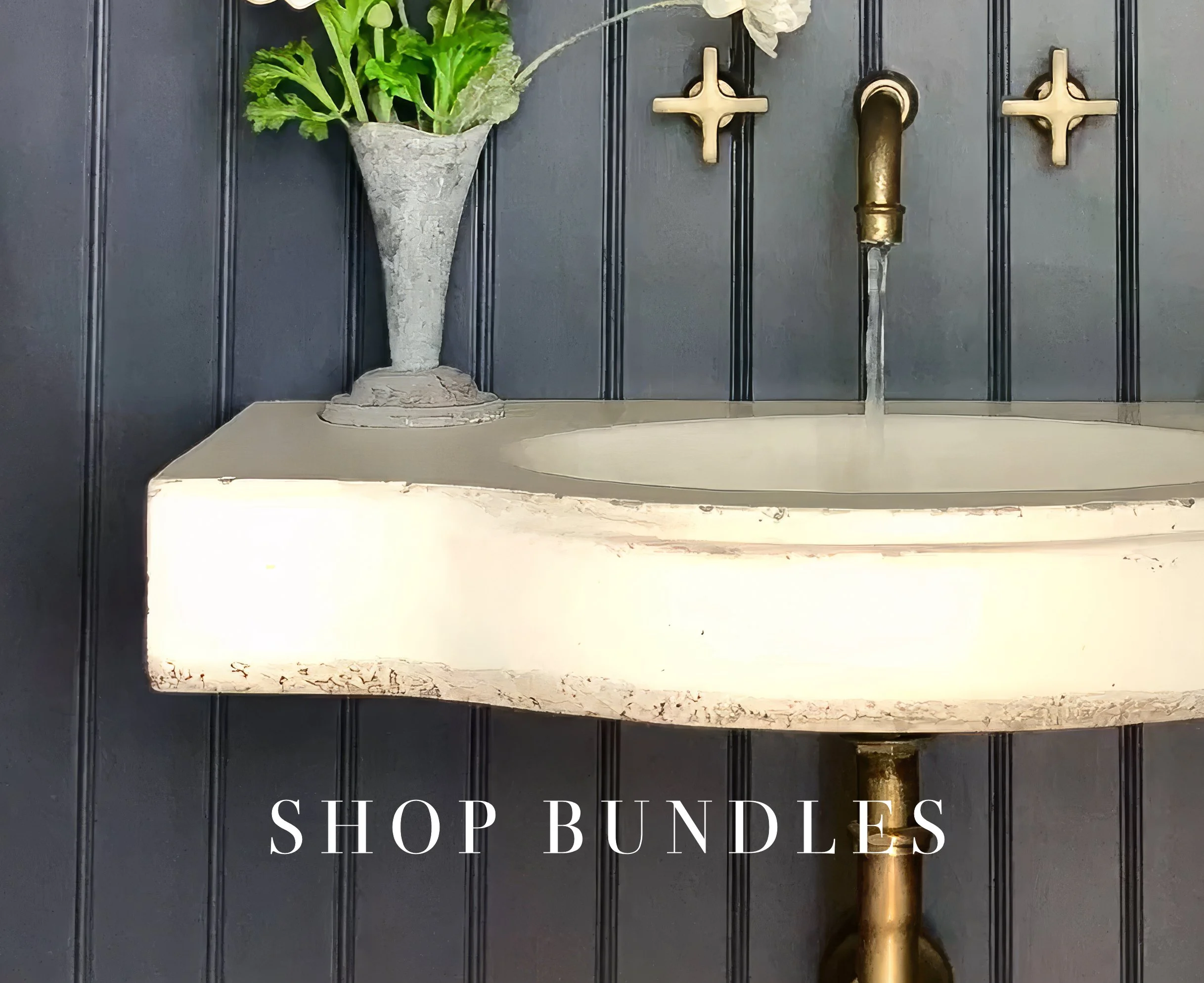 Luxury bathroom fixture bundles featuring handcrafted aged brass faucets and concrete sinks by Atmosphyre