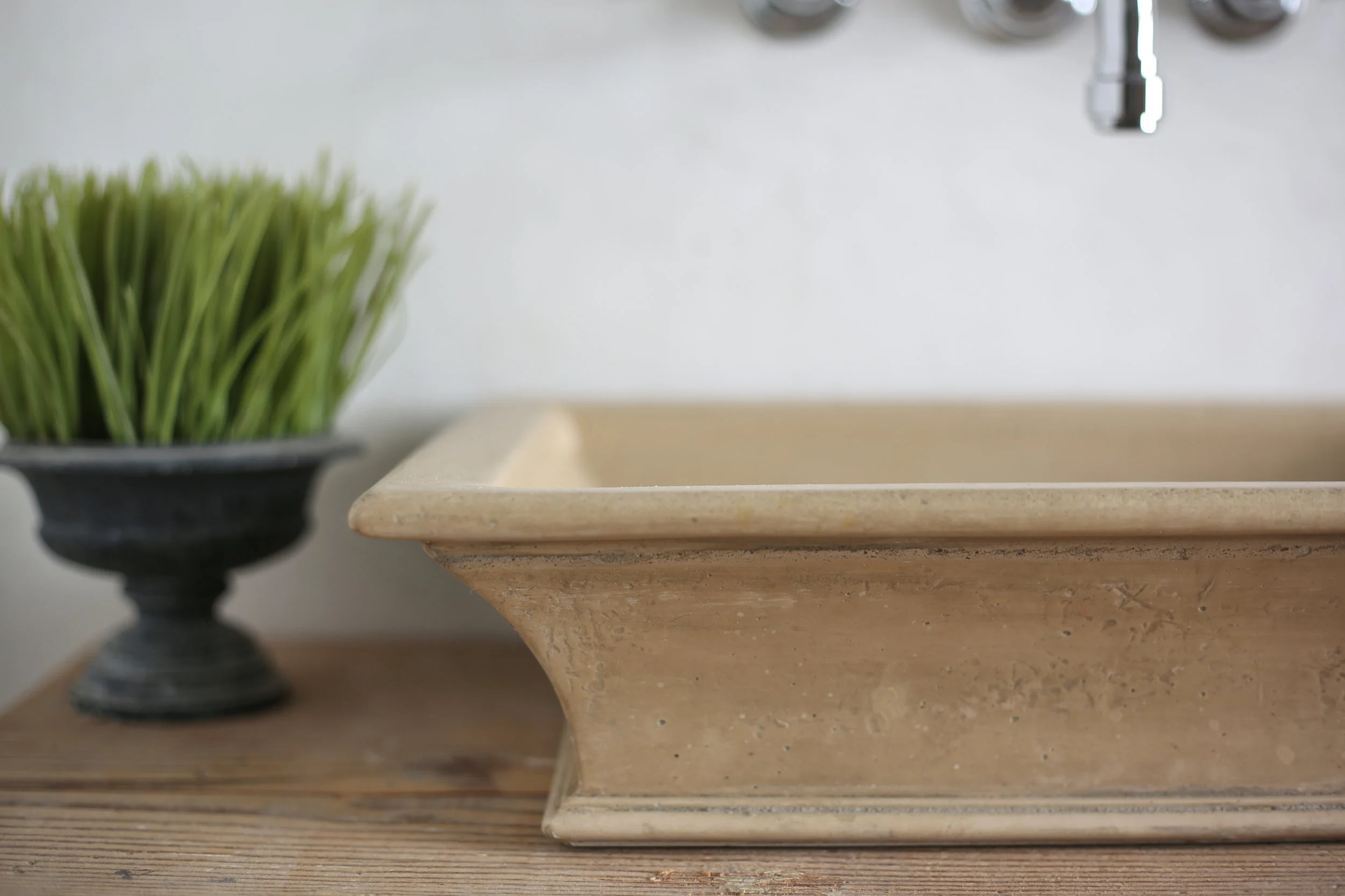 Close up of travertine classical sink by Atmosphyre.jpg