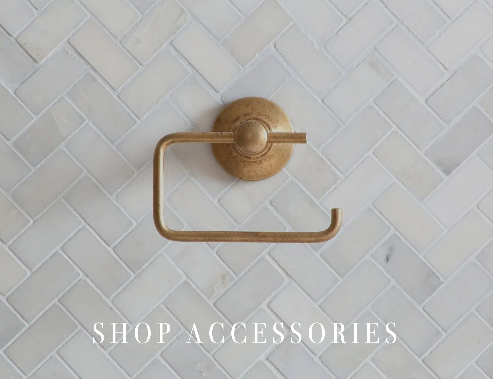 Aged brass and nickel bathroom accessories including robe hooks and towel bars