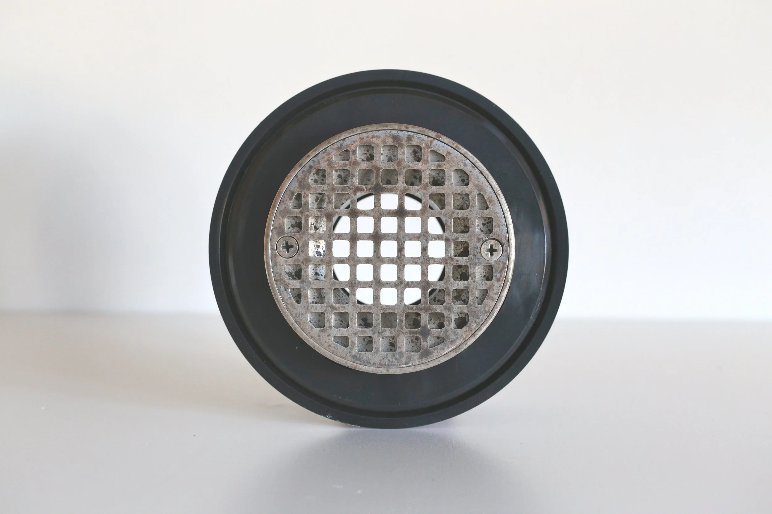 Aged nickel shower drain.jpg