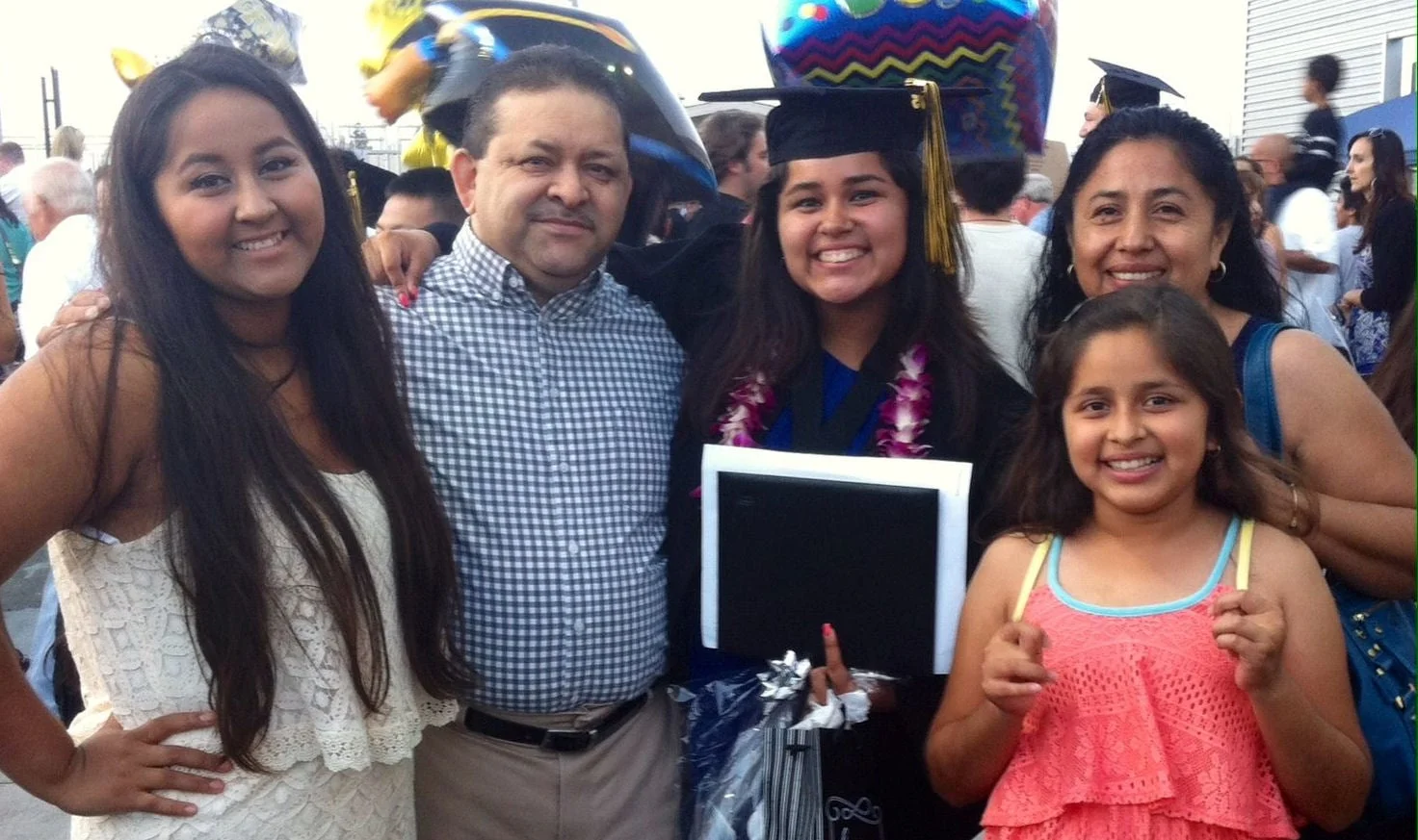 Verenice with her family at her graduation last summer. Her little sister Amanda (lower right) is going to The Oaks for the first time.