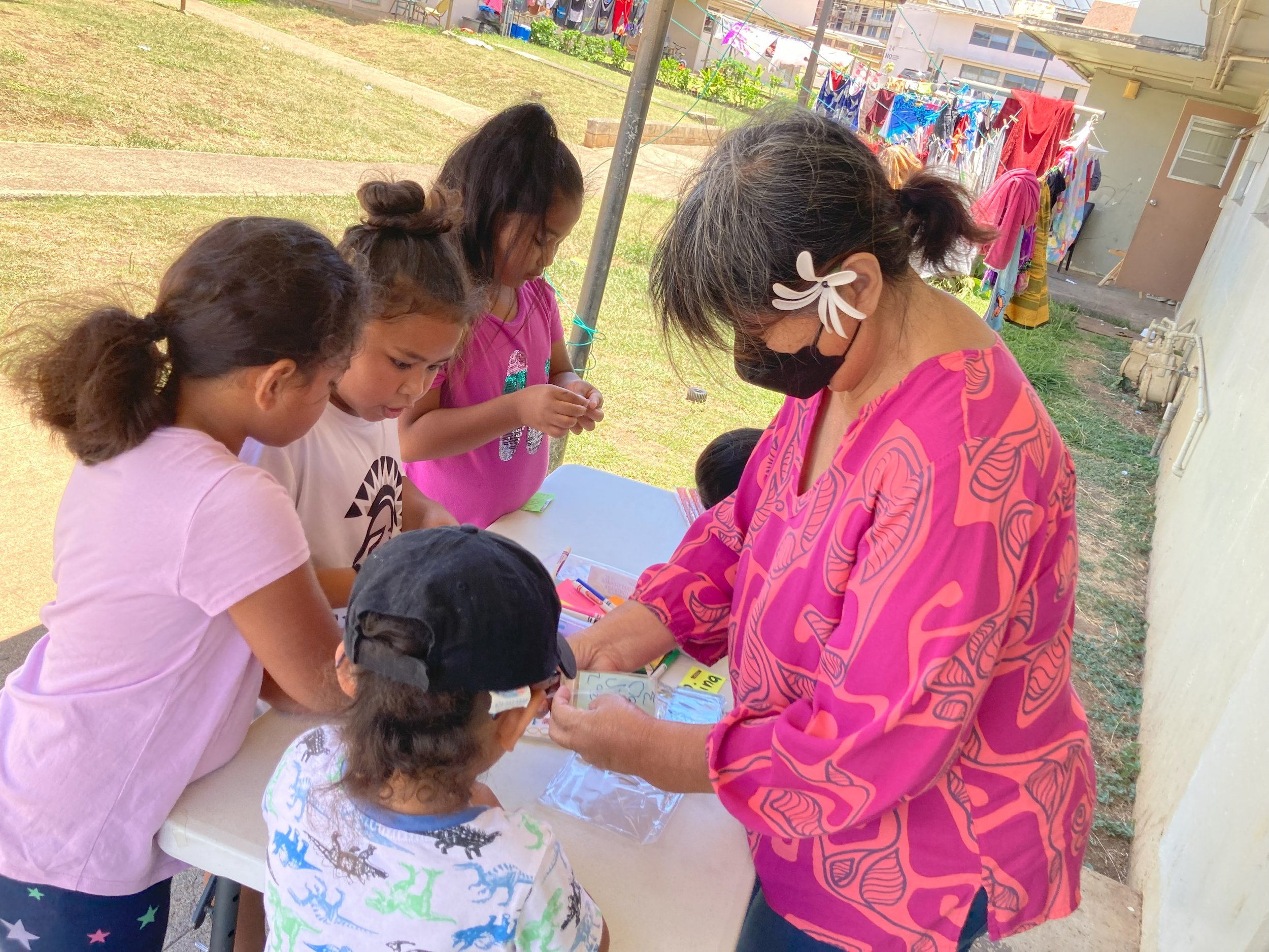 FLL manager, Rina, with the children at Mayor Wrights Homes.